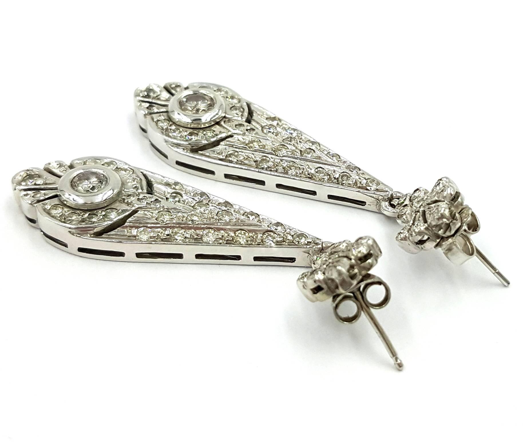 These absolutely bedazzling Retro 1950's Earrings are dripping in diamonds. Hand made during the 1940's to 1950's with incredible hand craftsmanship and precision. We start at the top of the earrings with a gorgeous organic flowing floral design