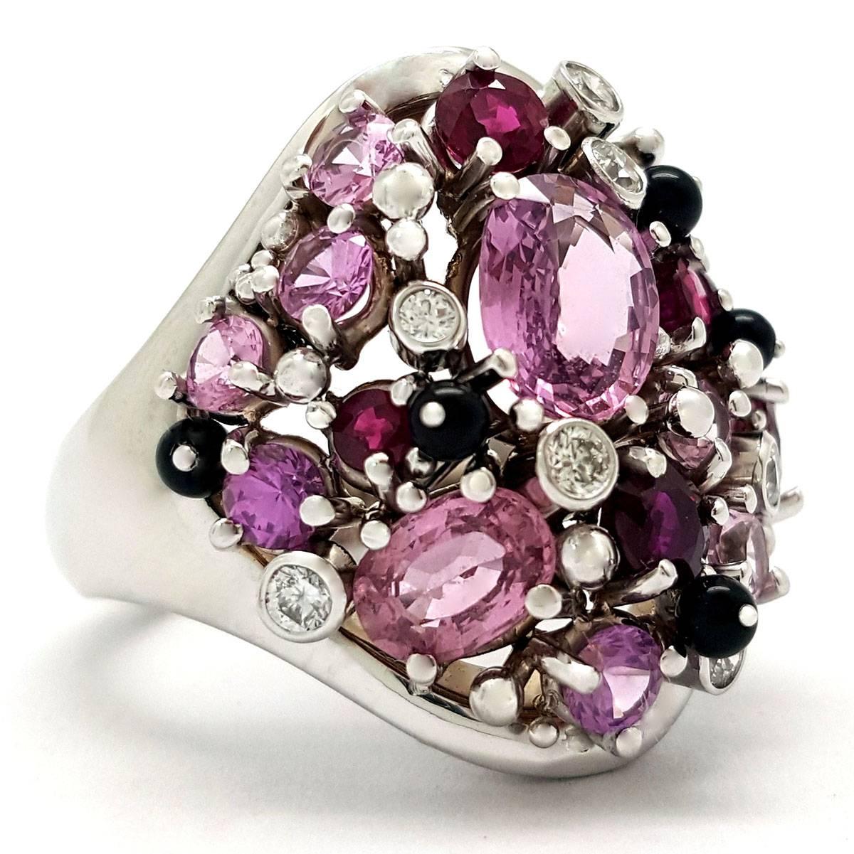 This chic cocktail ring features brilliant gemstones set into 14k white gold. The gemstones include pink sapphire, ruby, diamond and black onyx—a real gemstone party! The pink sapphires weigh 3.68 carats and the rubies have an additional weight of