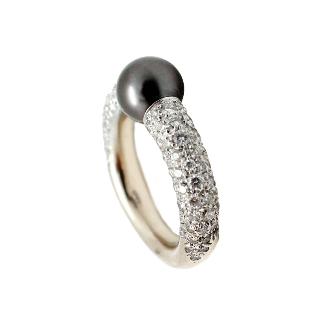 This stunning signed ring is made in 18k white gold by Mikimoto. It features an 8.3mm Tahitian black pearl as the center stone surrounded by brilliantly set pave diamonds in the band. In this gorgeous piece there are approximately 1.35 carats of