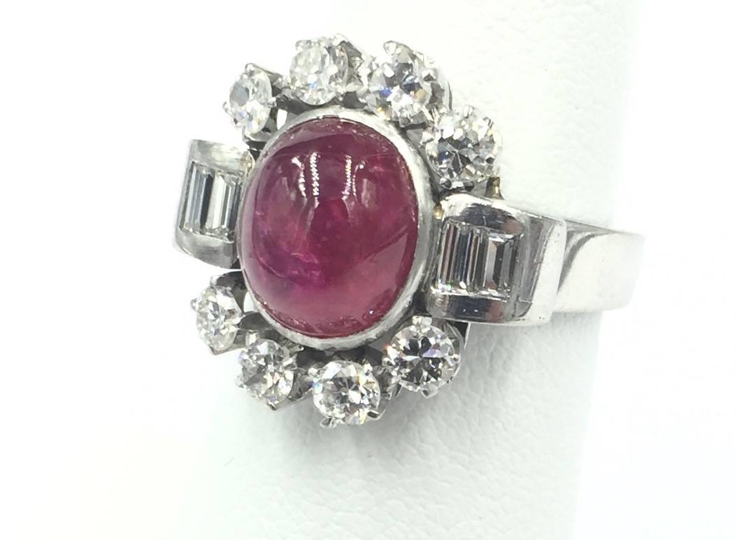 This impressive Art Deco period handcrafted ring features a 4 carat natural no heat treated Ruby Cabochon center stone surrounded by 1.50 carats of old european brilliant cut and baguette cut diamonds. An exceptional example of Art Deco. This ring
