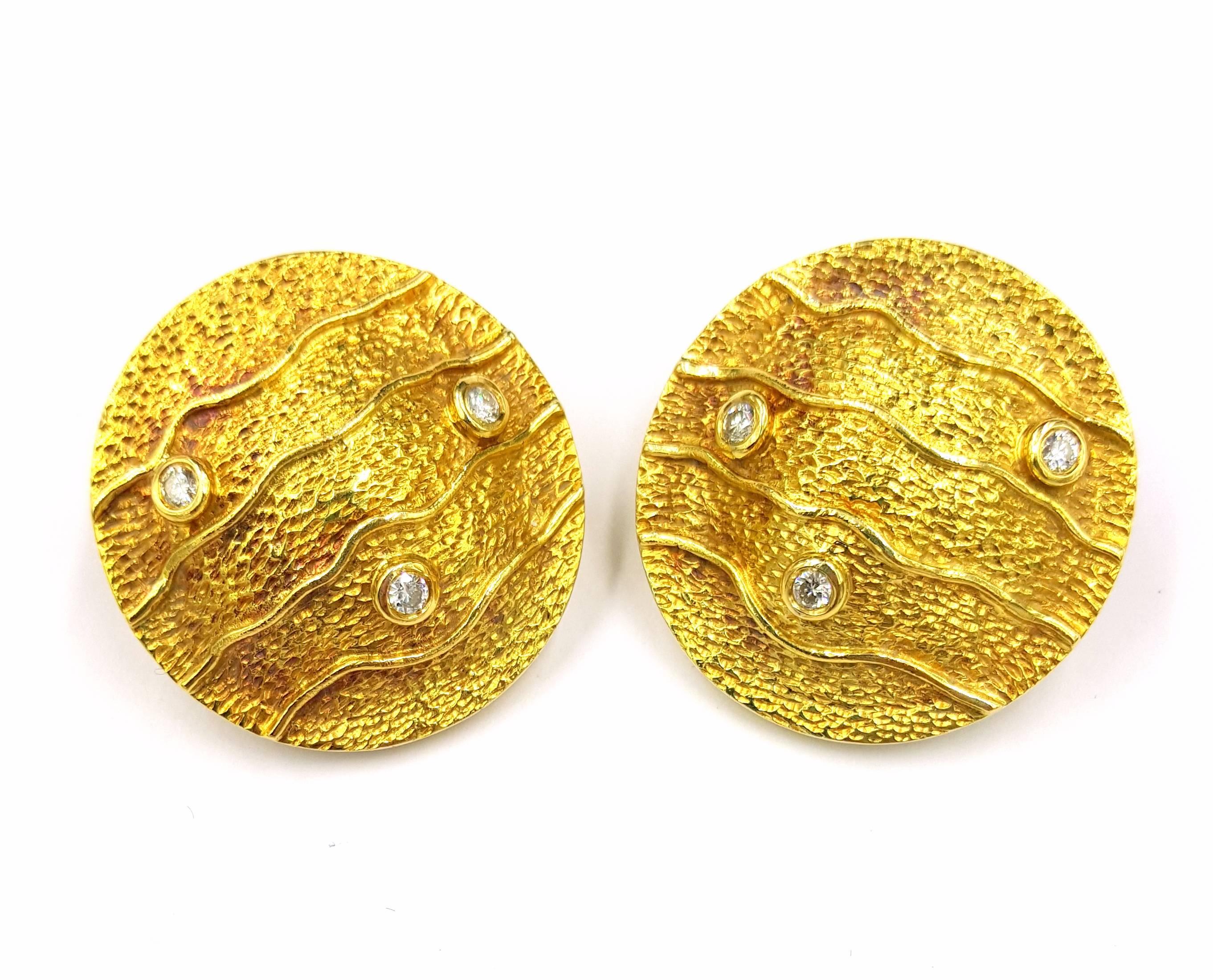 Gorgeous waves textured 18kt gold and .30 carats of VS clarity and F colored diamond clip on earrings offered by famous Greek Designer Mapamenos Natepas. These earrings are 1.25 inches in diameter and have a weight of 21.5 grams.

These Famous