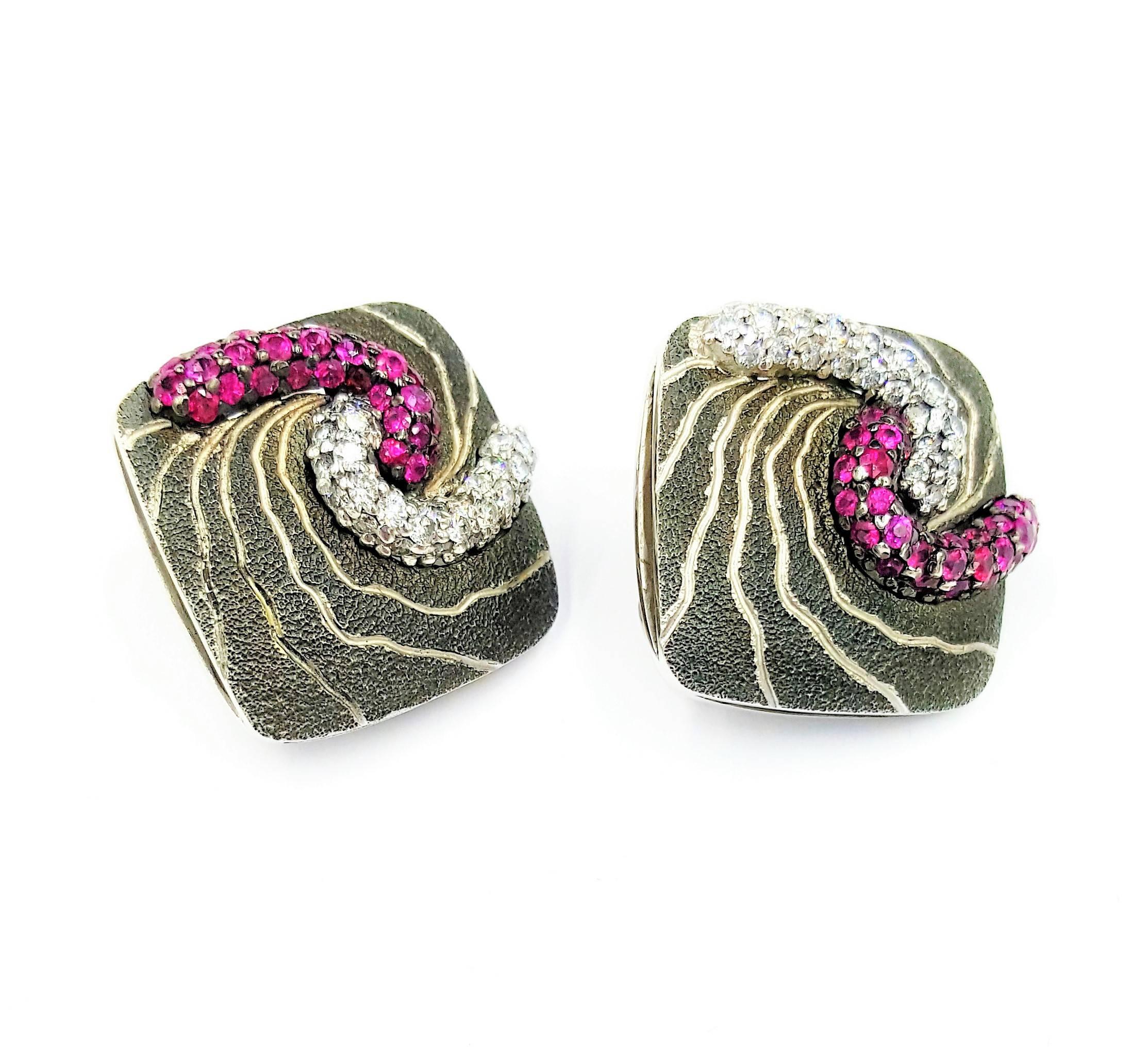 Designer Alex Soldier Swirls of the Earth featuring 1.00 carat of Rubies and 1 carat of VS clarity and G-H color diamonds. These earrings definitely catch the attention of any onlooker and are as gorgeous as they are peculiar. They are .75 inches