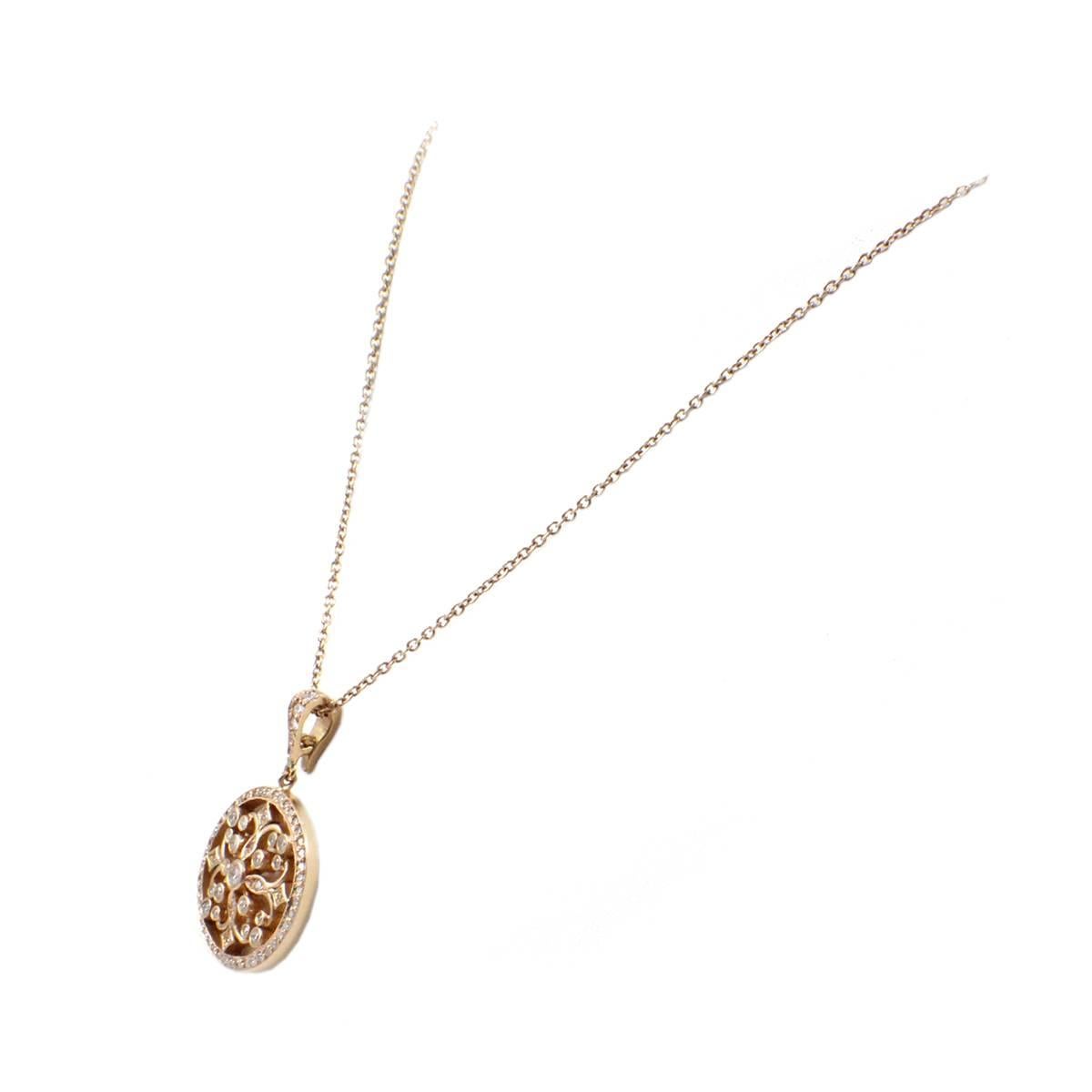 This beautiful necklace is made in 18k rose gold with diamonds by designer Penny Preville. The pendant features round brilliant diamonds for a total weight of 0.66 carat. The stones are graded G in color and VS in clarity. The pendant measures 23mm