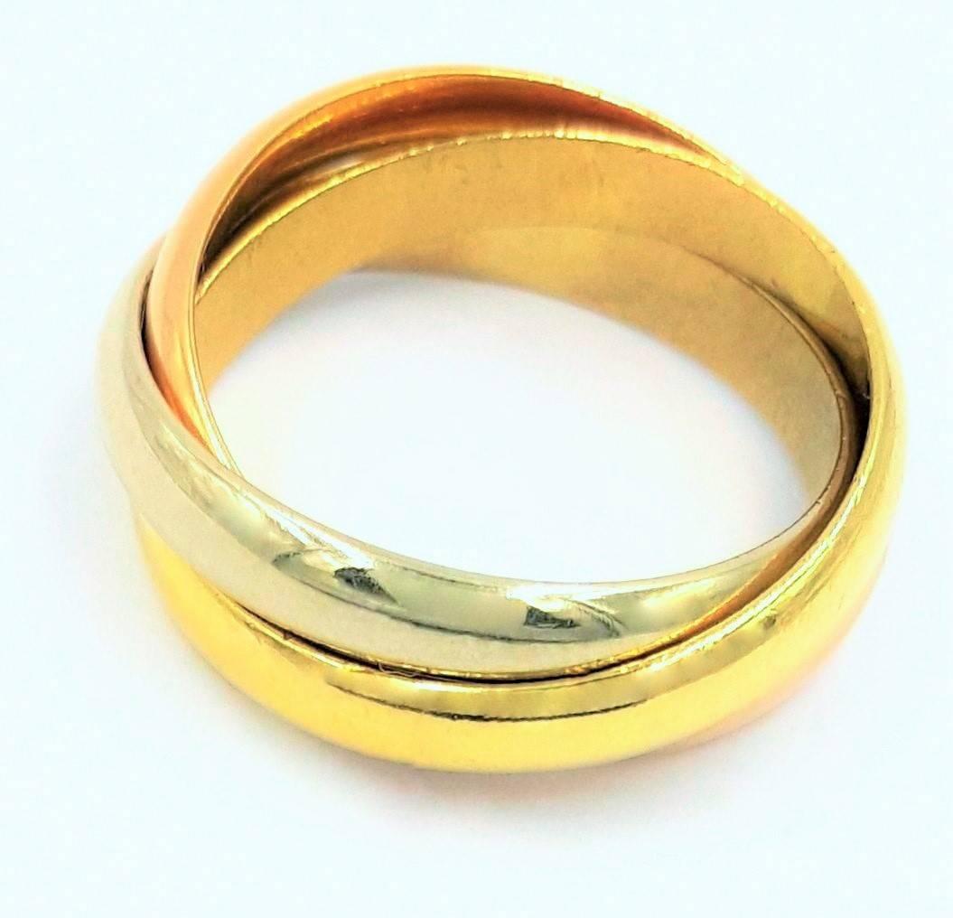 These timelessly popular triple rolling band rings by Cartier feature a handcrafted ring from solid 18 karat gold. Cartier uses all alloys of 18kt including, yellow, white and rose gold with a high polished finish this ring derives it's name from