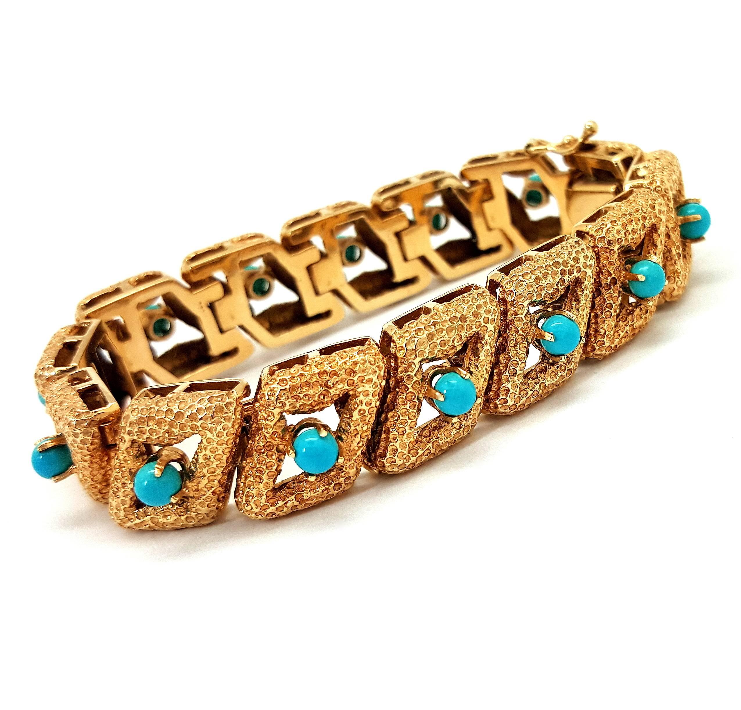 This magnificent bracelet is crafted with textured 14k yellow gold. It is designed with 14 prong set, cabochon cut, Persian turquoise gemstones. The bracelet measures 13.5 grams wide, weighs 49.42 grams and will fit up to a 6.5-inch wrist. This