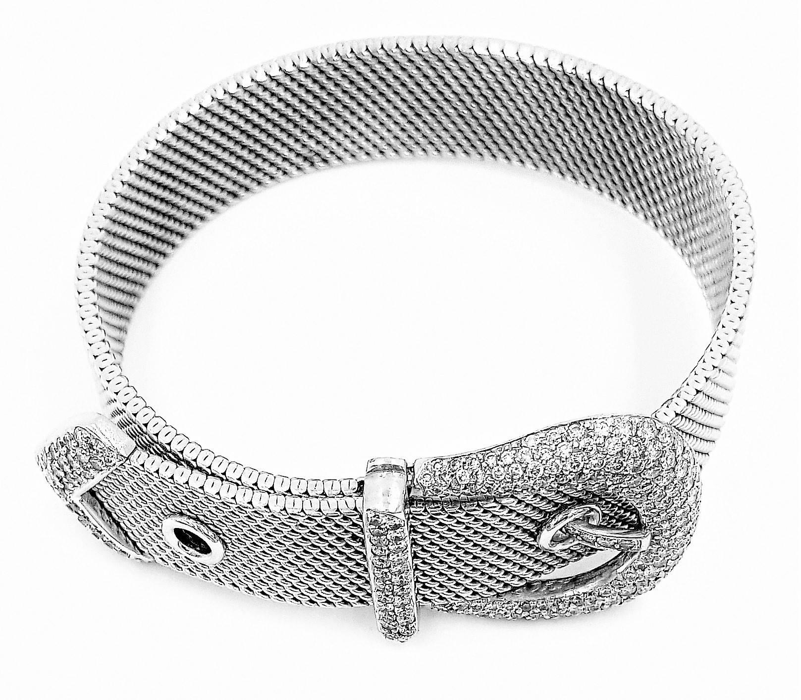 This gorgeous, hand crafted, flexible, fashionable, and also functional belt buckle bracelet features 3.00 full carats of ideal cut round brilliant diamonds with a clarity grade of VS and a color grade of F. The bracelet is stamped 18KT and we used