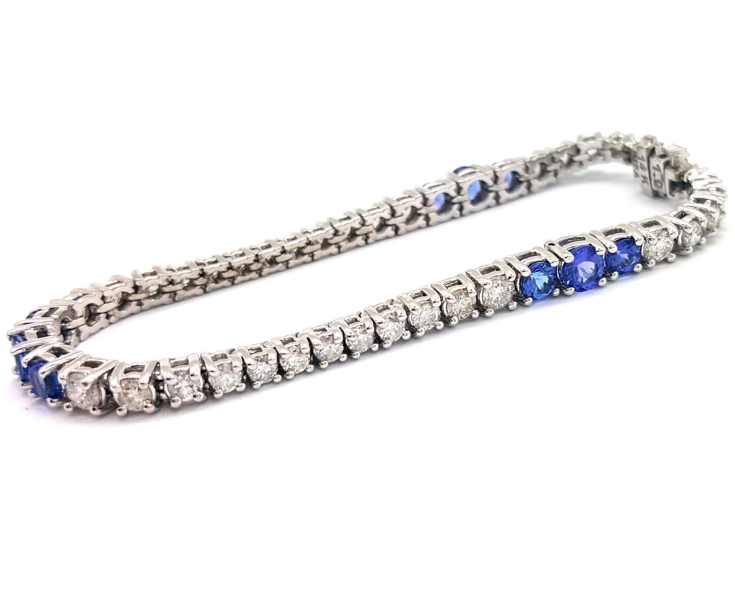 Noteworthy Color! This contemporary 14k white gold tanzanite and diamond bracelet is designed with 38 round brilliant cut diamonds set between three groups of three tanzanite gemstones. The way this bracelet is set makes it seem to undulate along