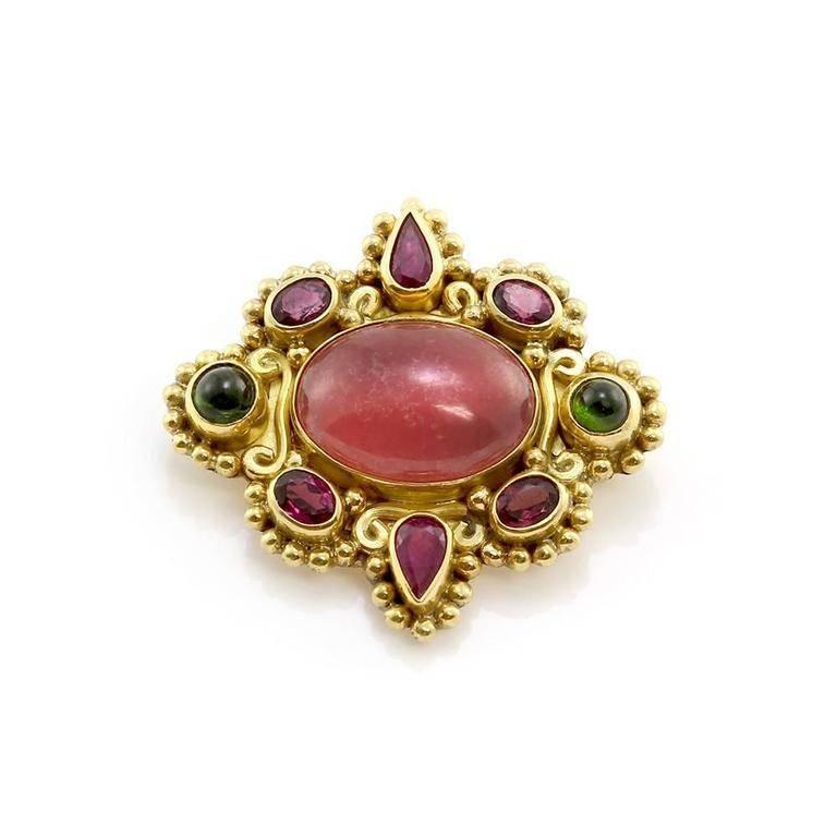 This creative 18kt yellow gold Signed Sajen is both a wonderful pin and a conversation starting pendant. Their is one gorgeous vivid pink oval cabochon cut rhodochrosite (.60inches x .45inches), two pear cut intense deep purple rubies (1.25inches x