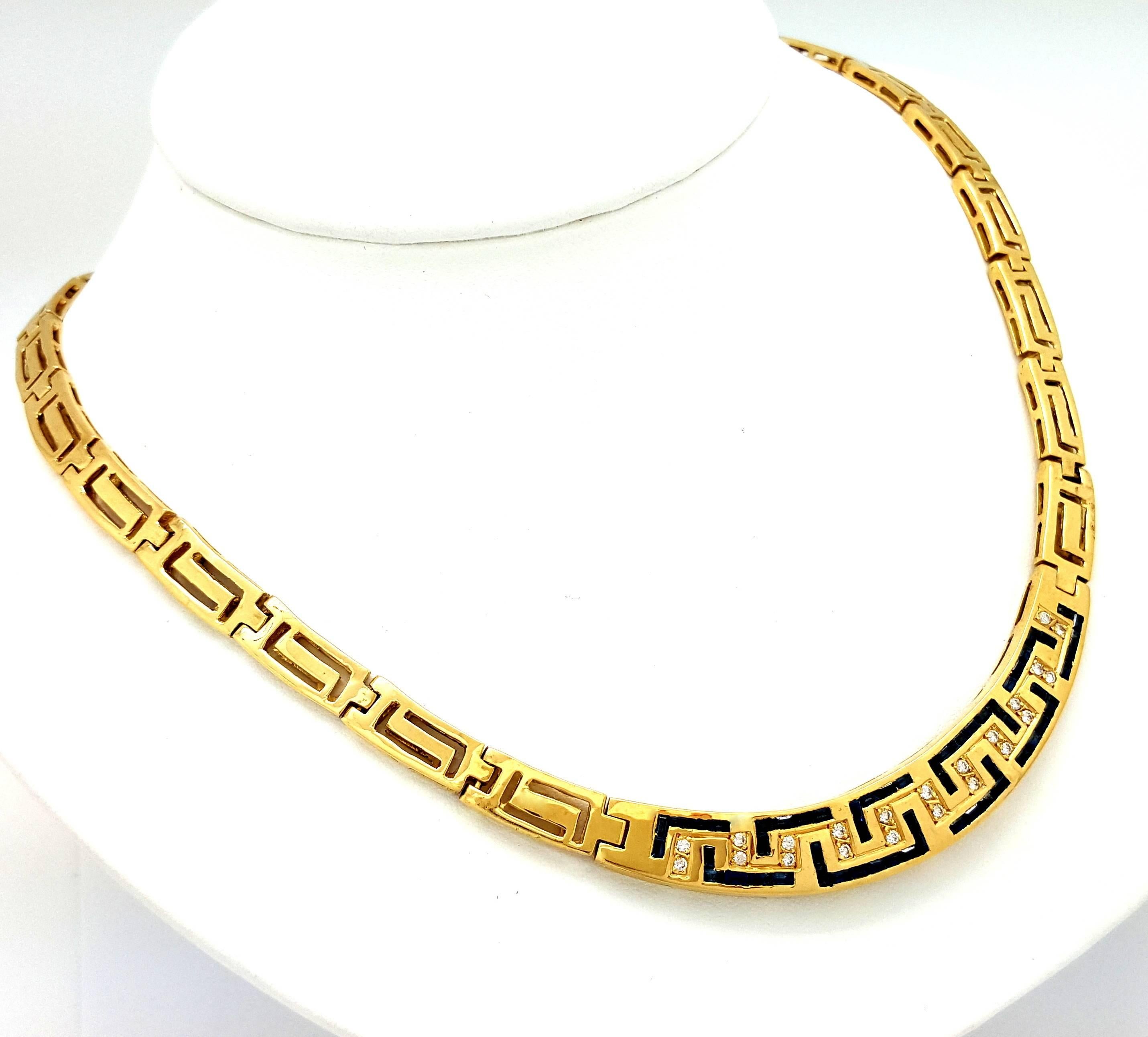This fabulous collar necklace is made in solid 18k yellow gold. It features both round diamonds and square-cut blue sapphires. The diamonds have a total weight of 0.44ct, and they are graded G-H in color and VS in clarity. The collar measures 12mm