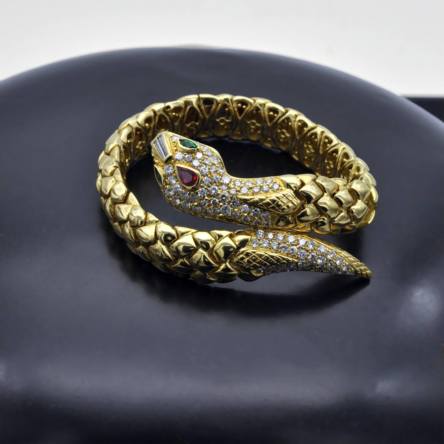 A flexible snake bracelet pavé set on the head and tail. 
Two long diamond baguettes are set on the nose, one pear shape Ruby on the head and emerald marquises for the eyes.

Diamonds: 3.19 cts / Ruby : 0.35 ct 

