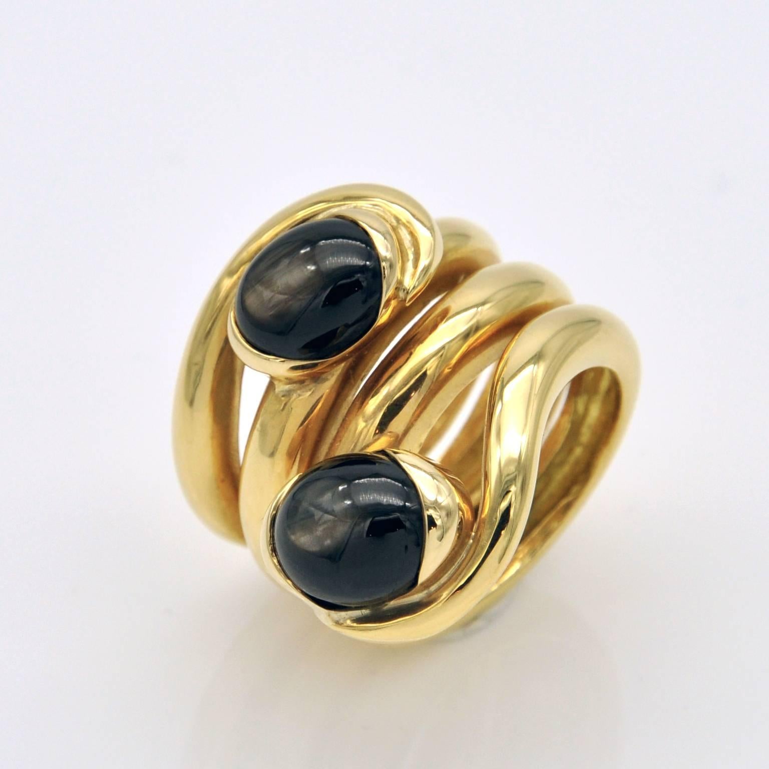 This Hand made ring is like stem that delicately wraps around the finger holding two oval black star sapphires.

Ring Details: 
Black Star Sapphires 7,85 carats .
French Hallmark

Ring Size: 6 ¼ (US), 52.5 (European). Resizing if possible is