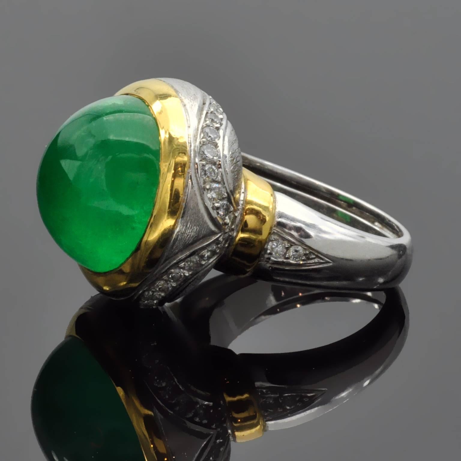 This is a truly unique handmade dome ring with a rounded turban shape. in its center a 13 carats  round Cabochon Emerald is framed in yellow gold. The rest of the ring is in white gold expertly crafted:  textured or shiny or engraved or set with