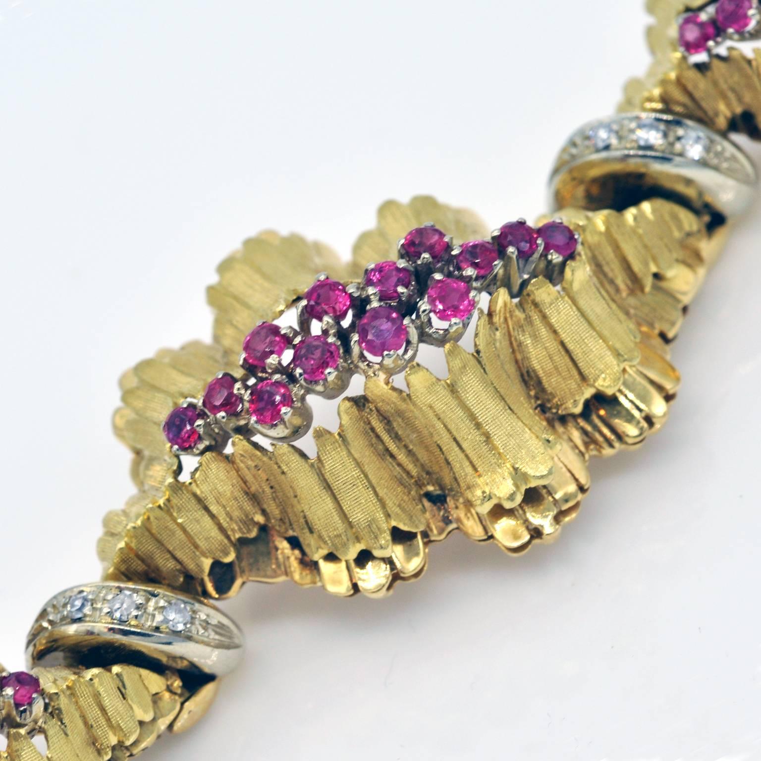 This bracelet is composed of 7 elements. Each of them are made of two layer of wave shaped yellow gold holding a cluster of rubies on white gold .The bottom layer is polished to be shiny the upper one is textured by engraving.  between each element