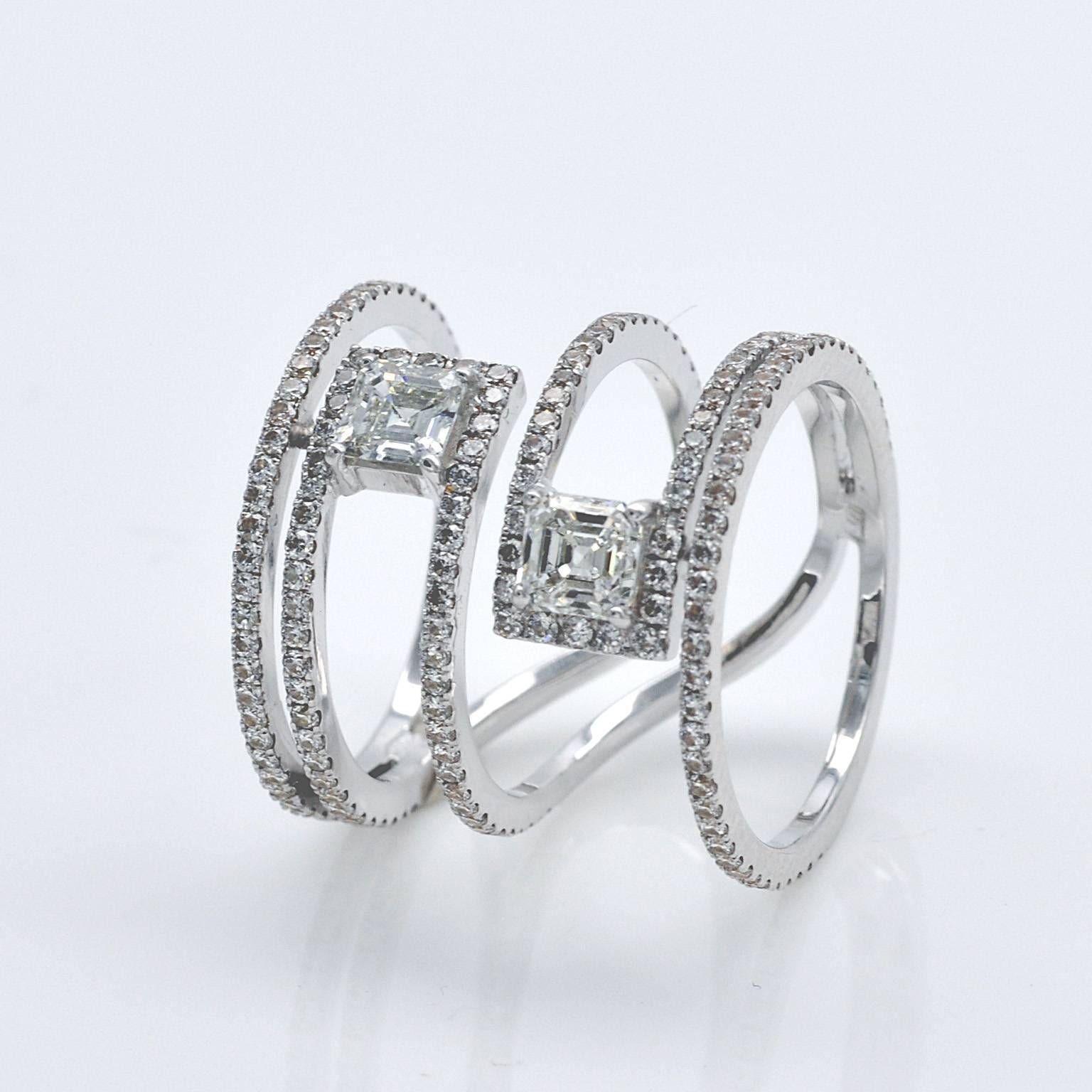 A thin white gold band set with diamonds winds elegantly around the finger in wide geometrical pattern highlighting two 