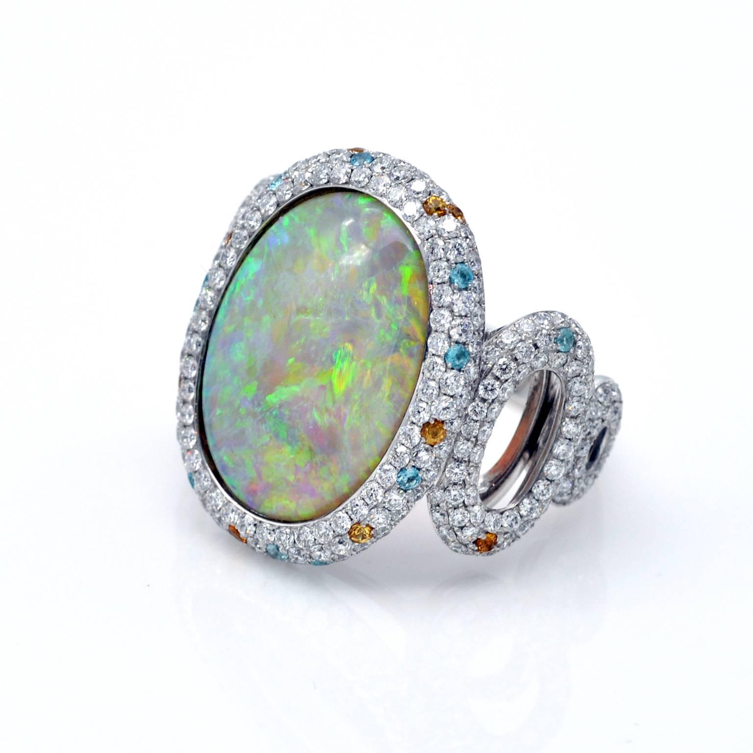 Amazing Australian opal set in a wide modern cocktail ring pavé set with white diamond, highlighted with brillant cut multicolored stones.

Opal 8.35 carats, diamonds 2.10 carats