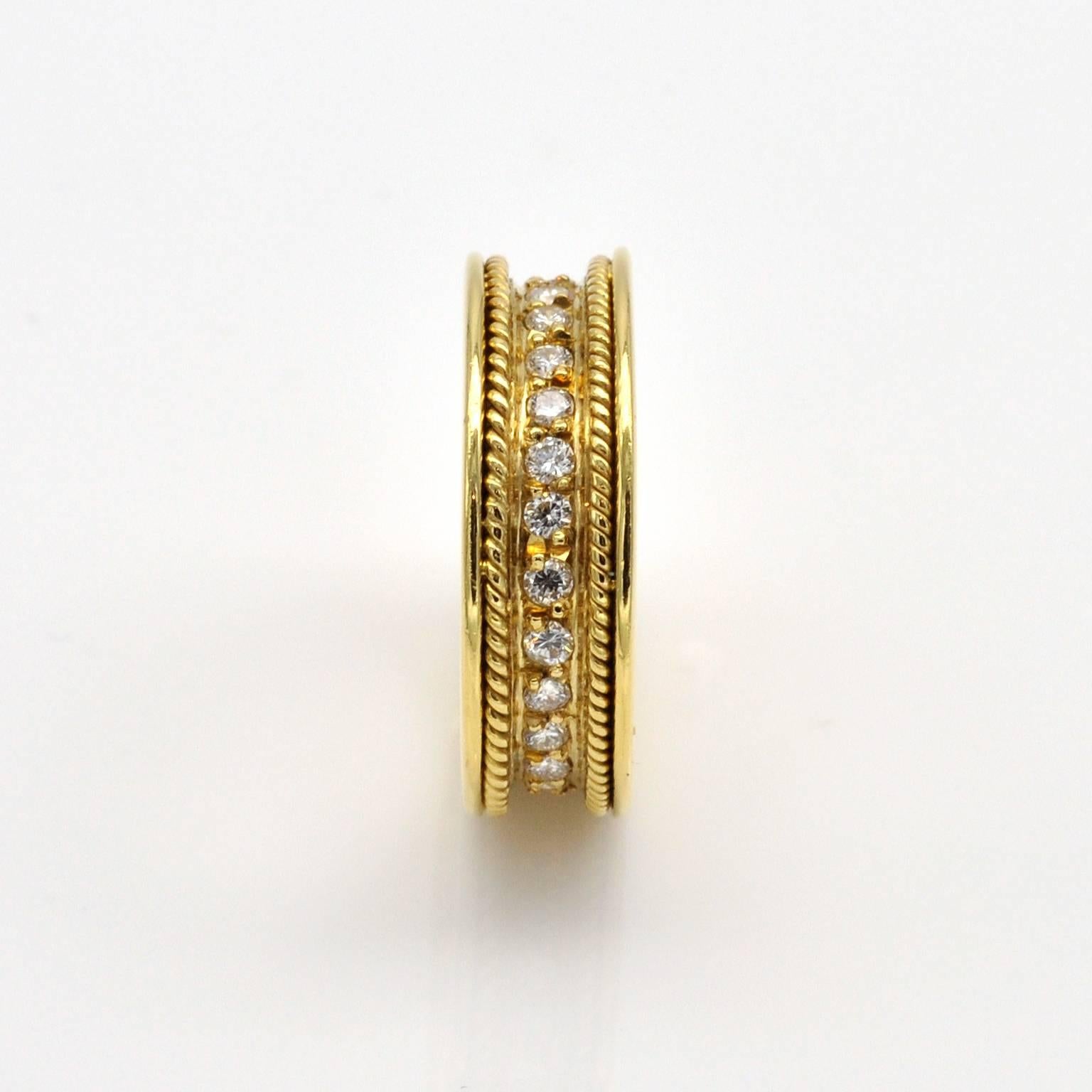 Exquisite handmade eternity ring . The sides of it are very simple and modern shiny yellow gold; in its midst two braided gold wire gives it an antique touch while a line of 27 brilliant cut diamonds enlightens the wedding band and makes it truly