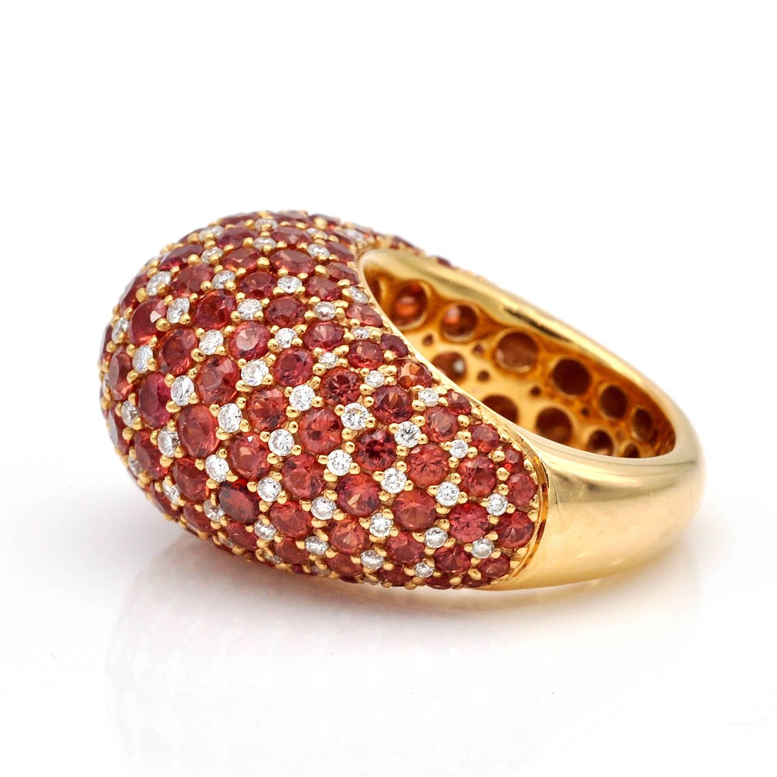 Brilliant cut Pinkish Orange sapphires and diamonds set on a perfectly shaped dome ring.

Sapphires: 8.52 cts , Diamonds : 1.19 cts
weight : 16.35 Grams

Ring Size: 6½ (US), 53 (European). Resizing is possible.

