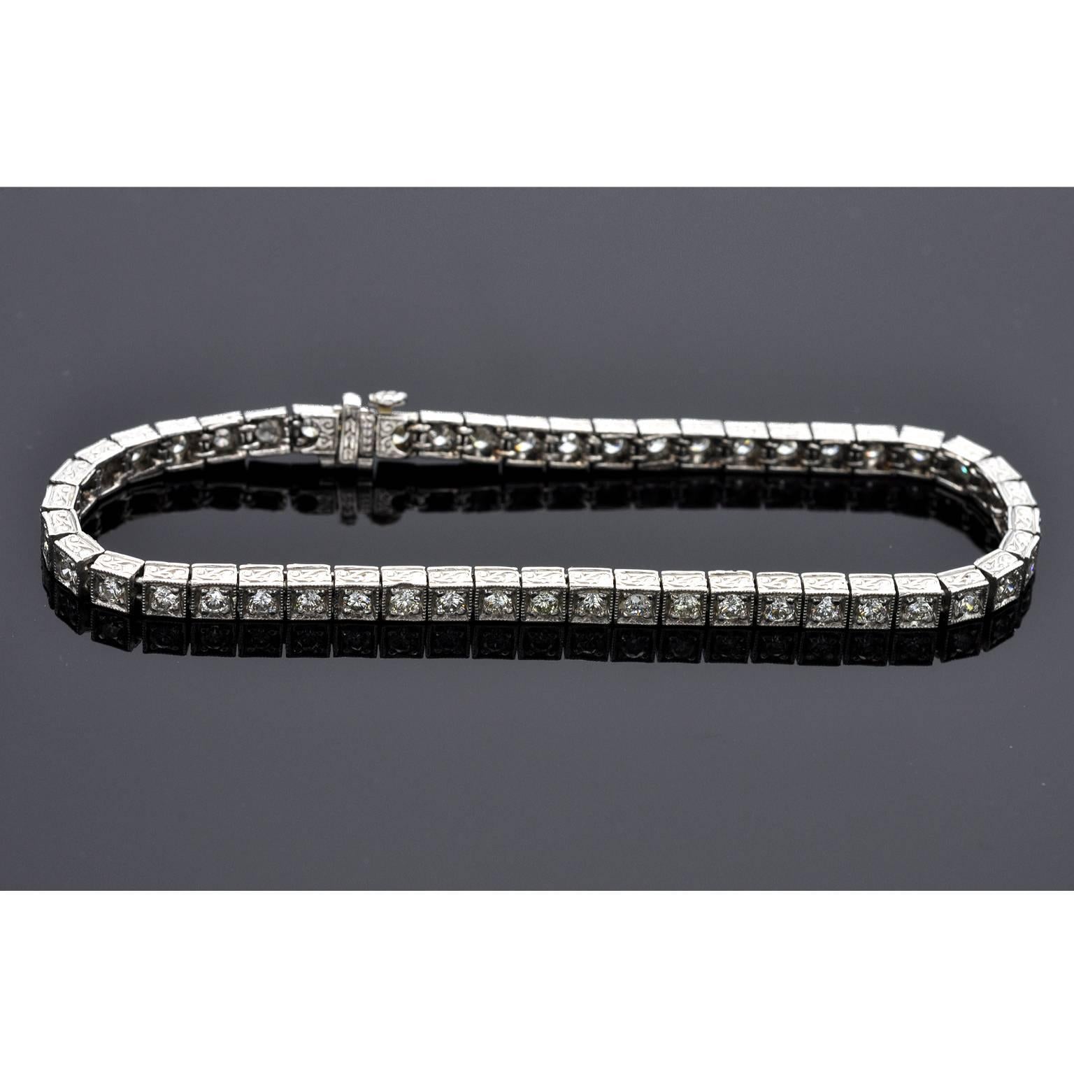 Art Deco Line Bracelet, Finely crafted in platinum set with 49 brilliant cut diamonds approx. 3.5 carats, H-I color, VS1-SI1 clarity, Beautiful Hand work detailed with milgrain borders and engraved sides.  it has an engraved insert clasp with hidden