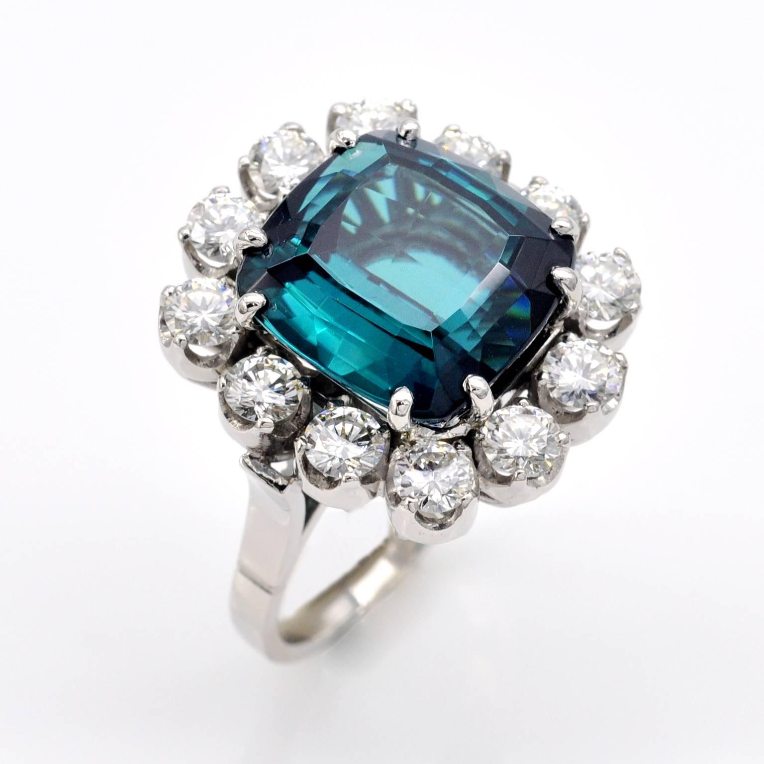 Beautifuly cut cushion shaped indigolite (blue tourmaline) set in a platinum cocktail halo ring.
Fine Blue tourmalines have always been sought after for their beauty and rarity. They have become even more fashionable these last years due to the big