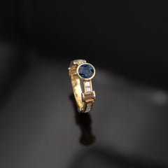 Anello articolato in oro bicolore 18 carati con zaffiro blu e diamanti