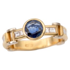 Anello articolato in oro bicolore 18 carati con zaffiro blu e diamanti