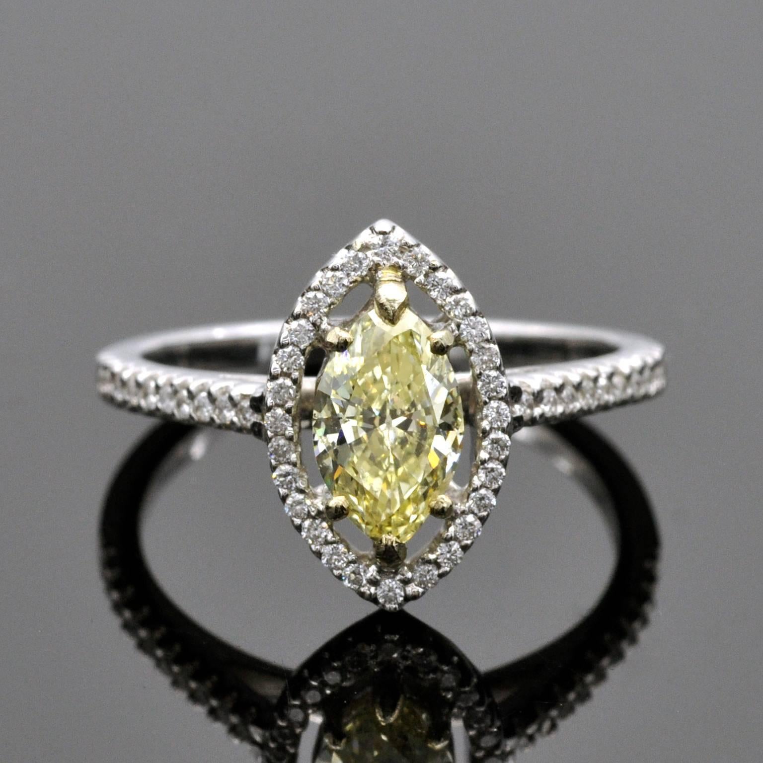 The center diamond, a 0.79 carat fancy yellow marquise cut diamond, set in an timeless 18KT white gold halo ring, comes with a certificate from the esteemed HRD lab in Belgium.
The ring is in mint state and has never been worn. it comes in a Claris