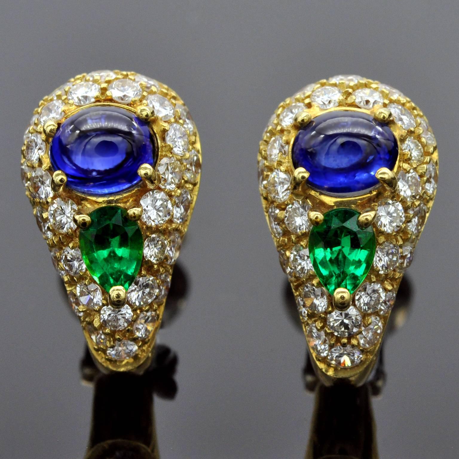Exquisite Clip-on earrings and ring set with vibrant lustrous stones.  
Details
Sapphire cabochon: 2.51 carat
Pear Shaped emeralds: 1.12 carat
Brilliant cut diamonds  (F-G, VVS-VS): 2.67 carat 
Earrings: 17mm x 9.9mm
Ring: 10mm wide