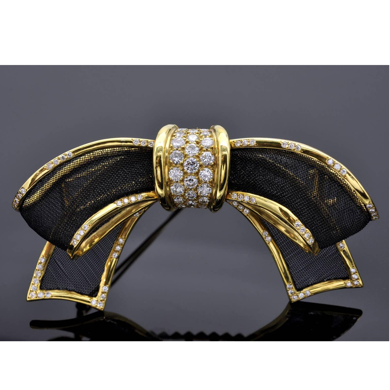 This is an extraordinary brooch ! The bow is made of blackened Gold fabric in a shiny yellow gold frame highlighted with diamonds .  The central Element is richly pave-set with diamonds ( up to 0,15 carat each ) nearly touching each other. On the