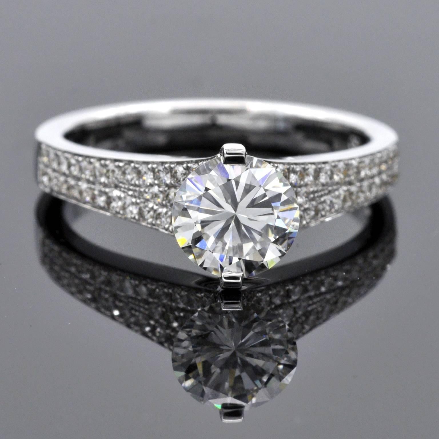 One of a kind engagement ring with a modern unique design. The diamond is set with two strong prongs that showcases it in a way that allows light in making the stone sparkle at its best. The band itself is set with 0,40 carat of brilliant cut