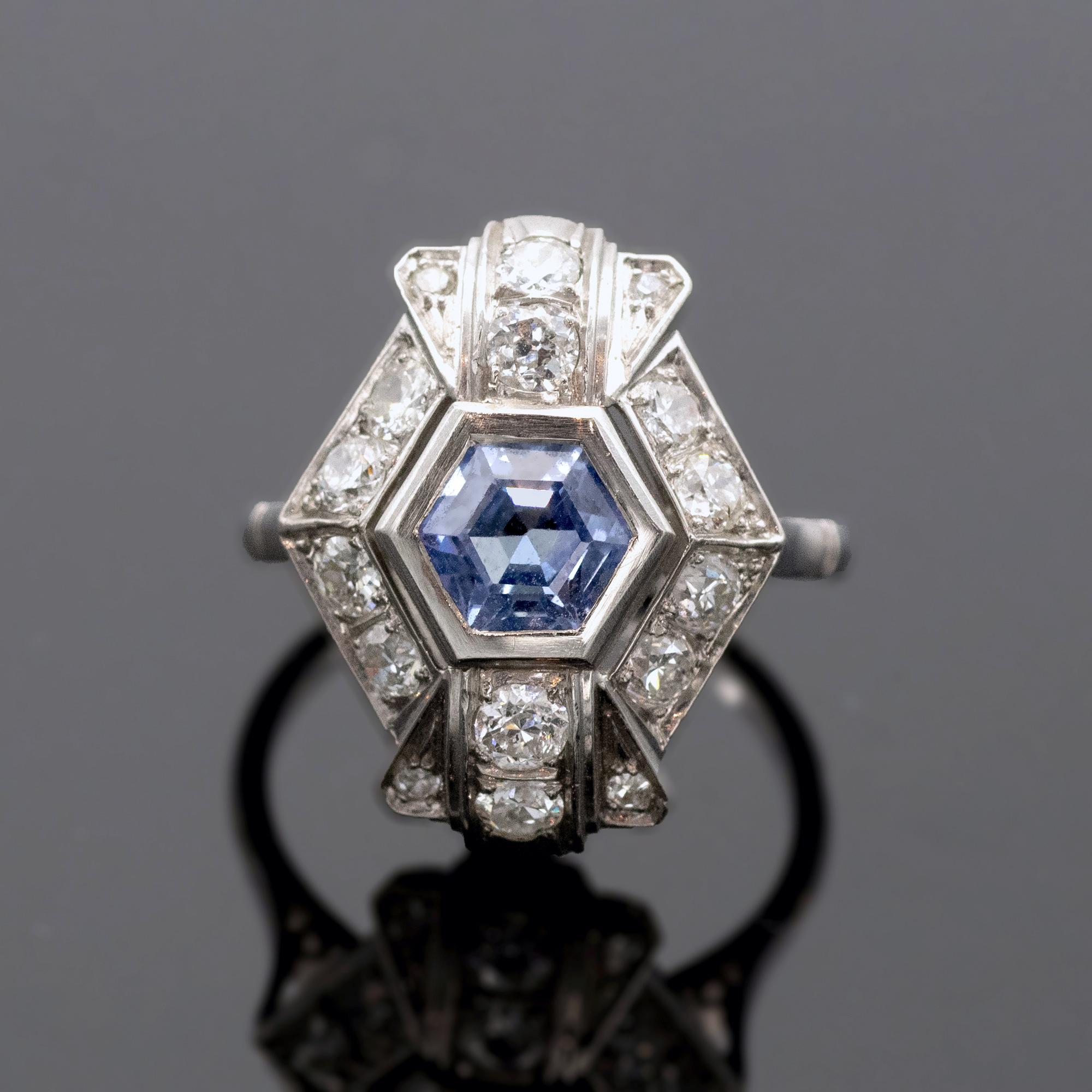 Art Deco platinum ring set in its center with a lively hexagonal sapphire and round diamonds.
The sapphire is ±1.25 carat, and there is approximatively 0.84 carat of diamonds.
weight 12.8 grams - French state hallmark stamp