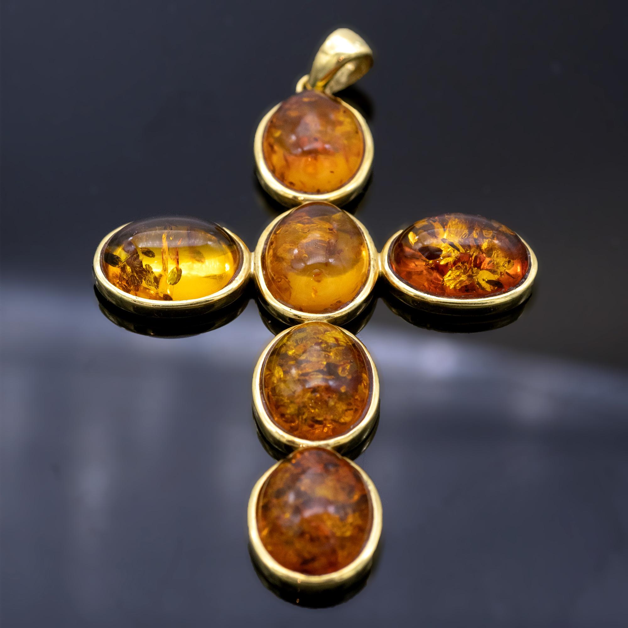 Modern Cross made of polished 18kt gold and honey coloured amber cabochons
Dimensions of the cross  : 7x5 cm 
whole pendant dimensions ( with the loop) :8.1x5 cm
