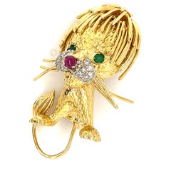 Spilla Leone vintage in oro giallo 18k con smeraldo, rubino e diamante