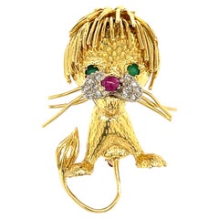 Spilla Leone vintage in oro giallo 18k con smeraldo, rubino e diamante