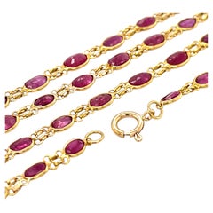 Collier en or jaune 14 carats avec un rubis ovale serti en lunette, 26"