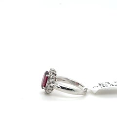 Platinum Oval Garnet and 0.31 Carat Diamond Halo Ring
