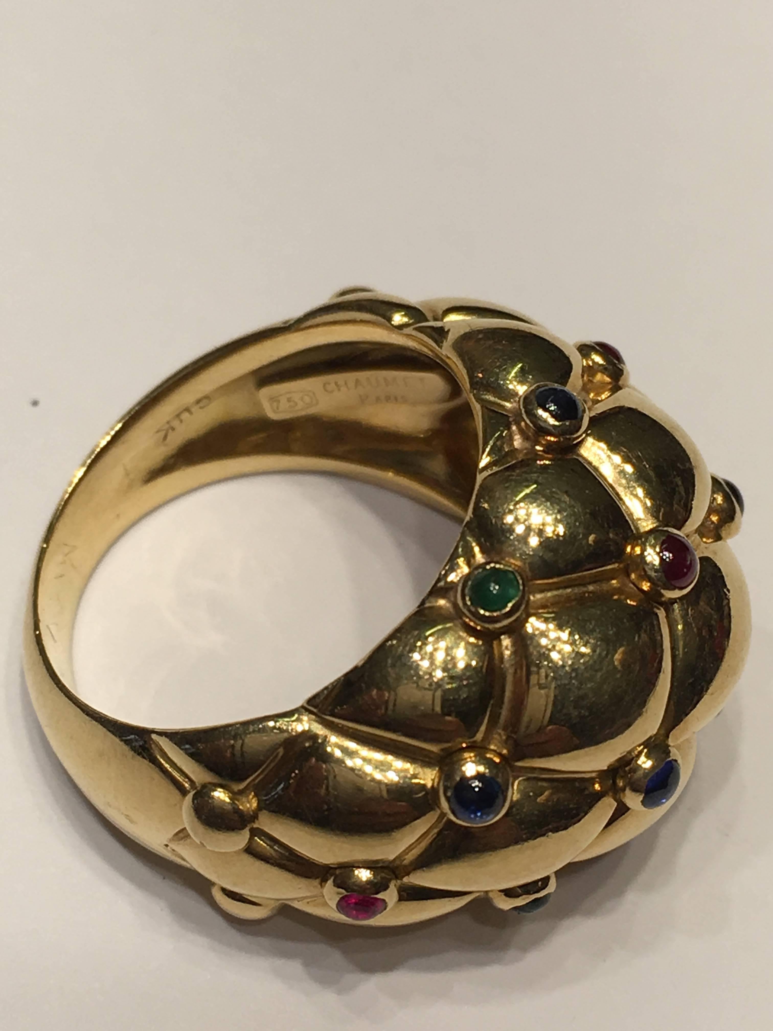 Chaumet Bombay Cushion Ring set with Cabouchon Rubies Sapphires and Emeralds. Set in 18ct Yellow Gold . Fully Signed by Chaumet.
SIZE UK (J)  SIZE (5.1/4) This lovely ring would suit any occasion.
Can be sized free of charge for the