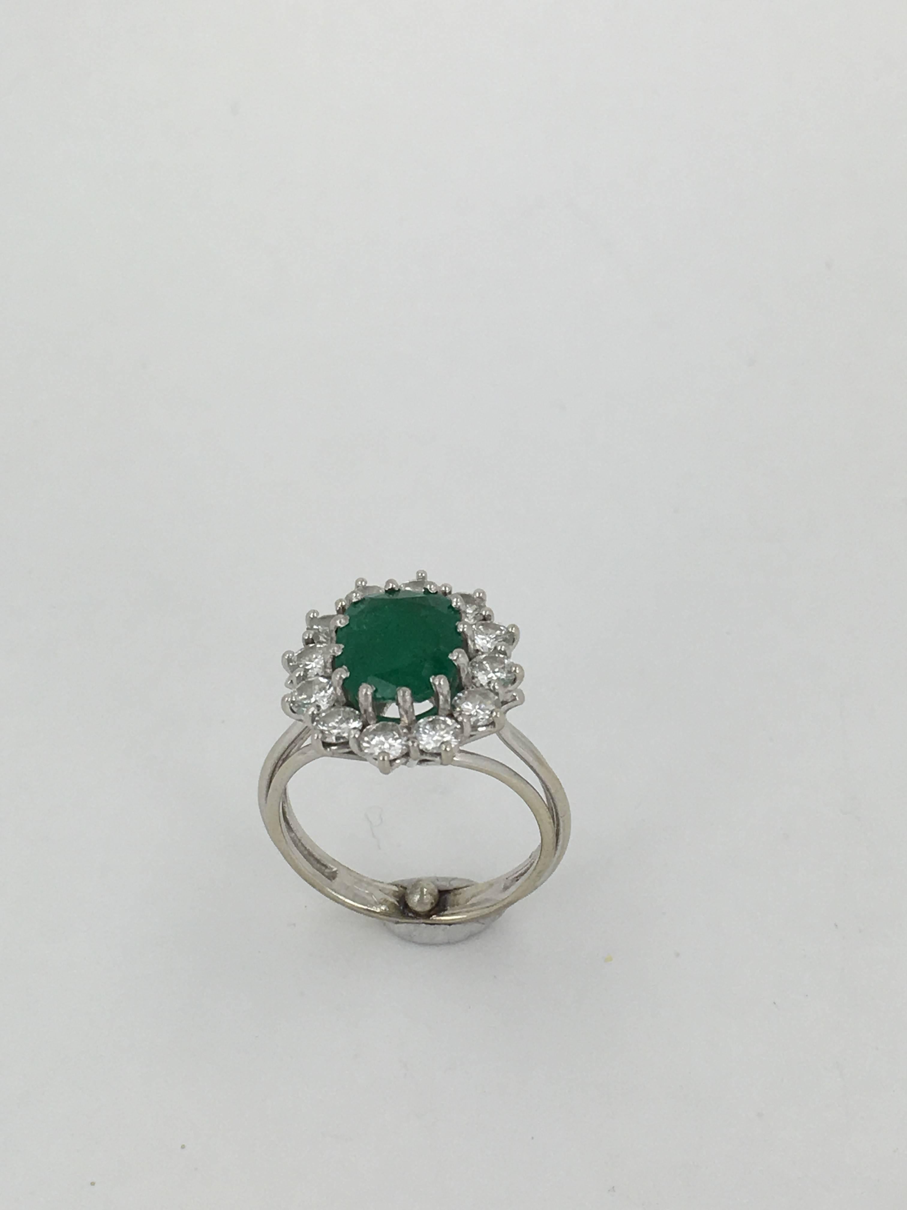 A Large Oval Emerald Approx 2..50CTS Surrounded by 1.50cts of white Diamond set in 18ct White Gold