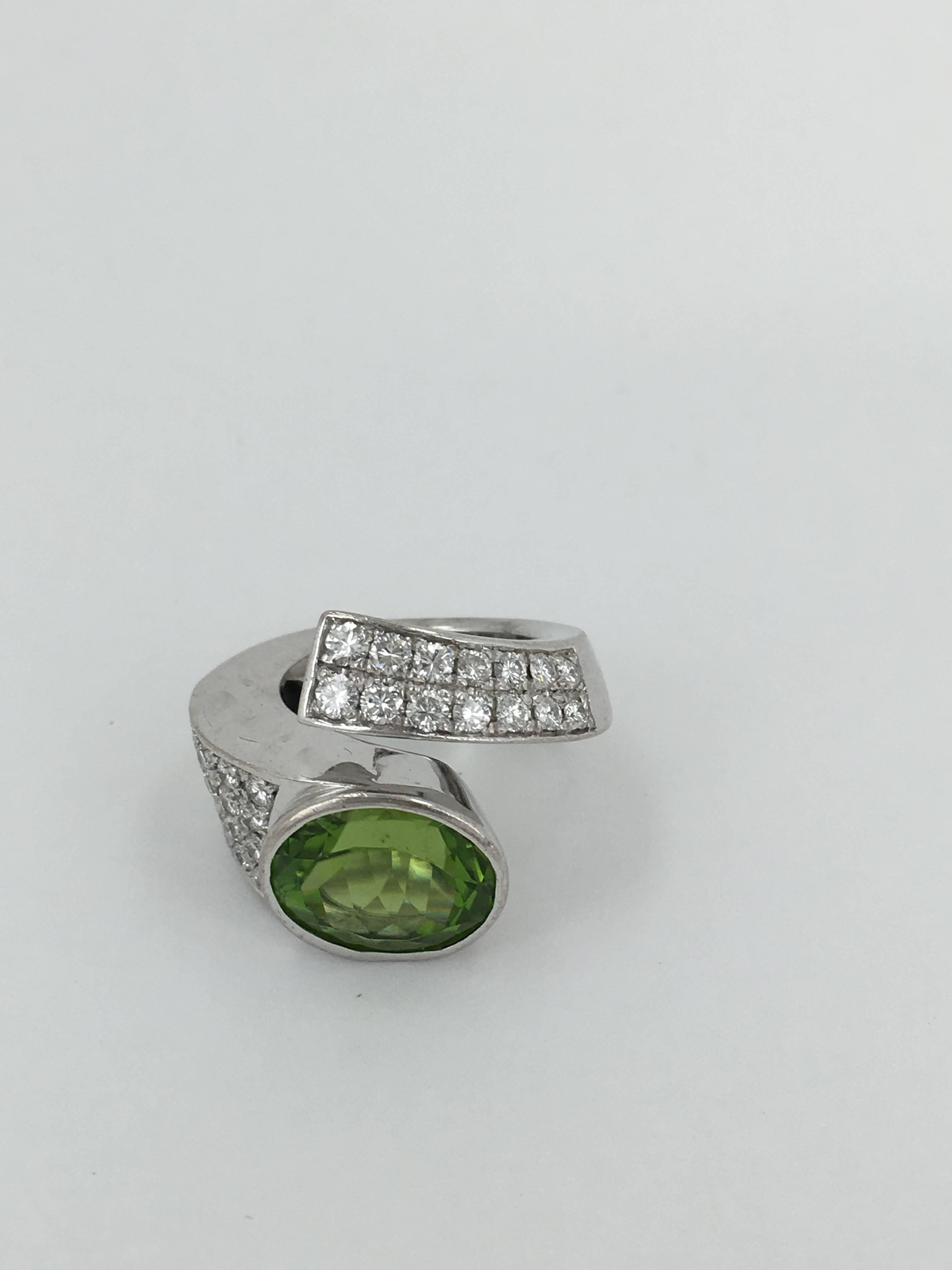 Peridot Approx 15cts set on 18ct White Gold with diamonds APPROX 3 CTS Ring
made by Wiemann 
A true statement ring to wow your friends !!!!!

SIZE UK ( M) SIZE US ( 61/5)