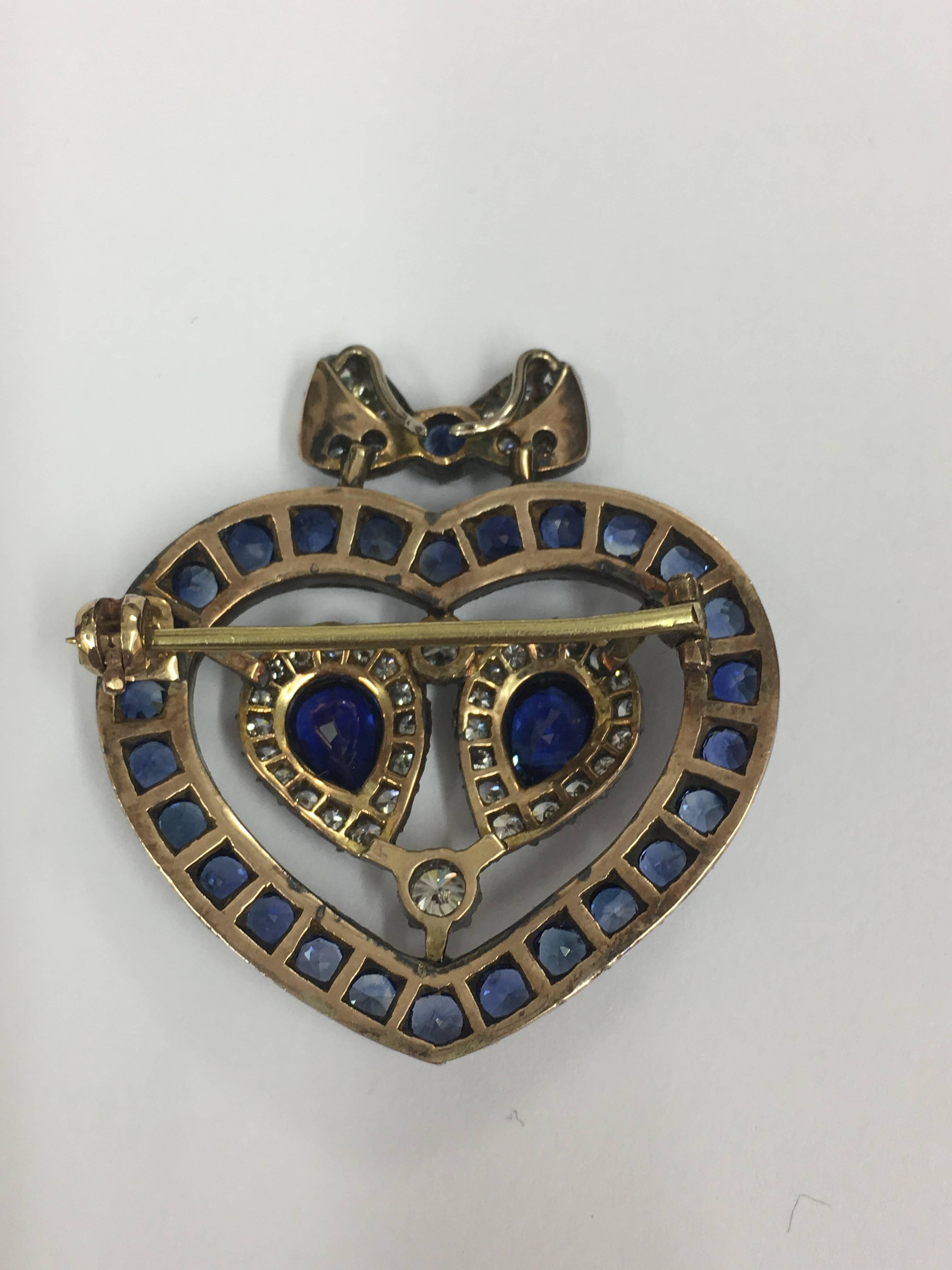 Love heart brooch made of white diamonds and  high quality sapphires with bow detail. Canbe worn as a brooch or pendant set in 18ct Yellow gold and silver, very fine work beautifully set. The style of the brooch is very Victorian but we feel that