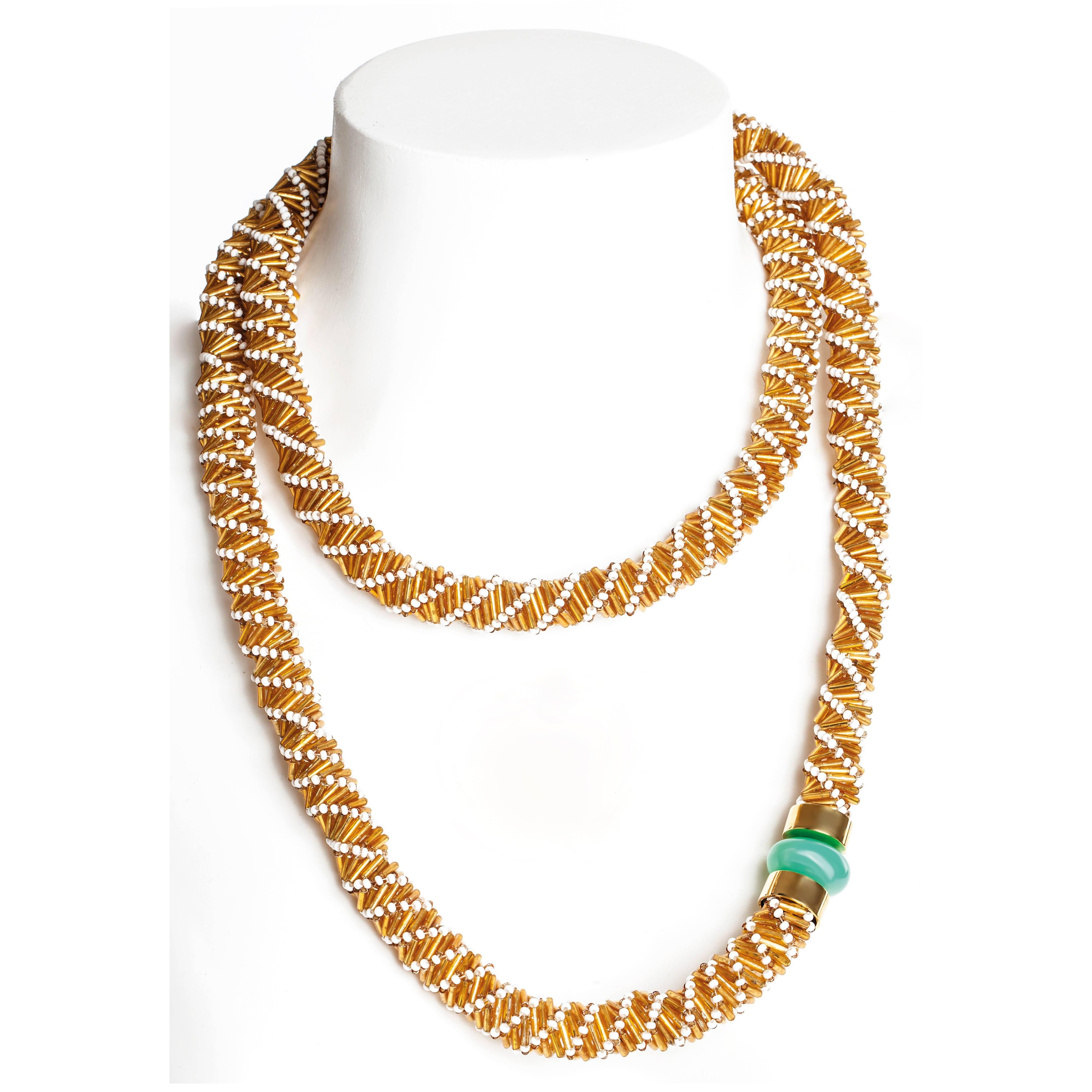 Hand beaded with the finest glass beads by Maasai women in Kenya; set with 20 carat natural chrysoprase gemstone bead and finished by hand in London with 18kt gold plated brass. Chrysoprase is sourced from conflict-free mines in Namibia and created