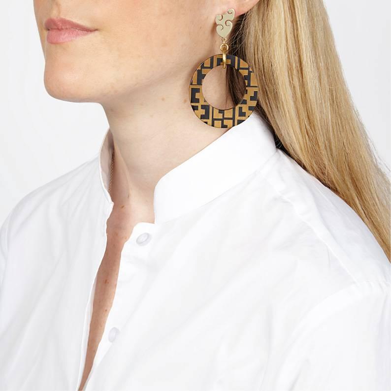 Dangle Earrings made from African cow horn, finely engraved with geometric design.

These statement earrings are crafted by artisans in Kenya, East Africa, and finished by hand to the finest quality in London. Earrings come pierced with solid silver