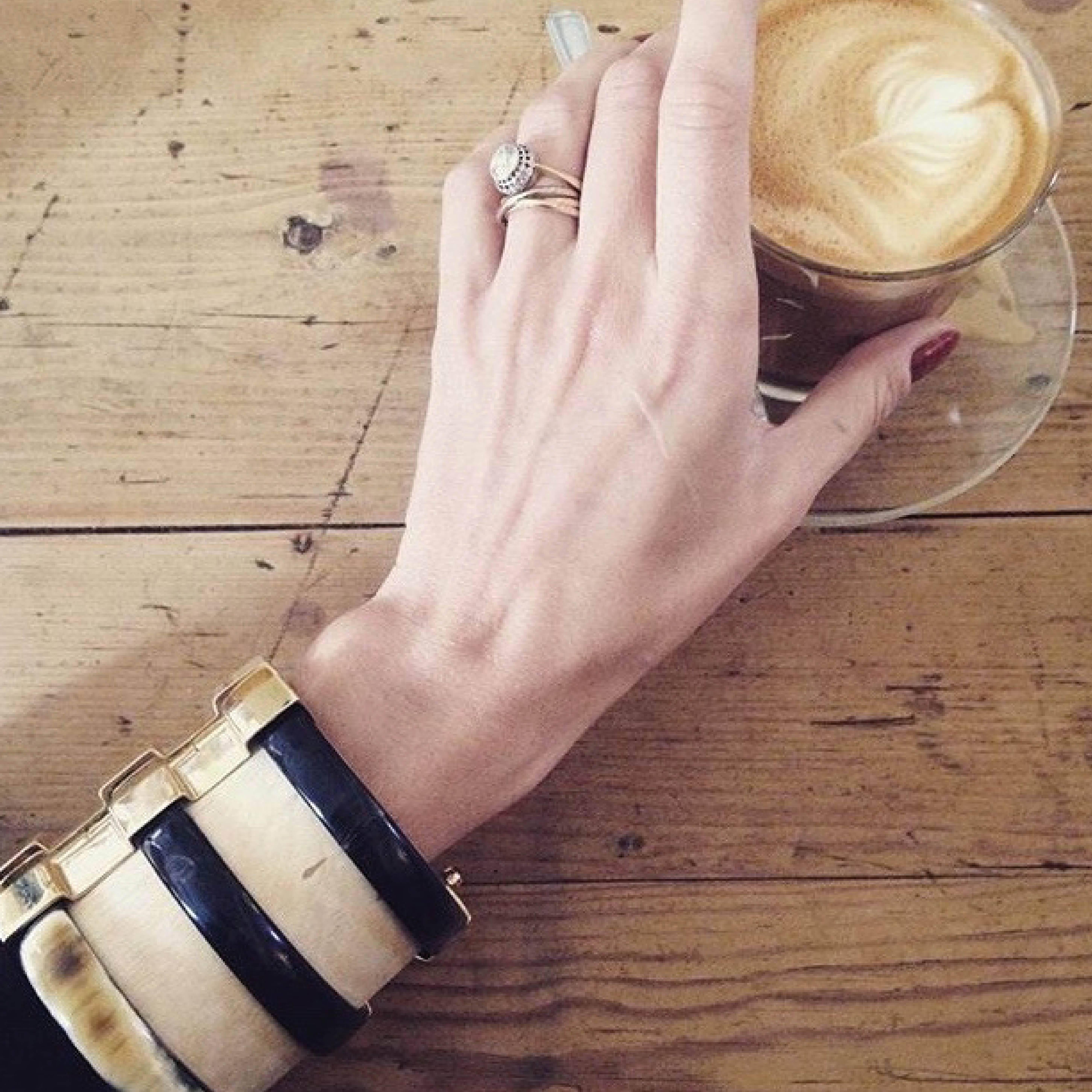 Cuff braclet crafted by hand from jacaranda wood and African cow horn. The customizable 18k gold plate pin-clasp is set with a choice of emerald, ruby or blue sapphire. 

Each cuff is handmade from natural materials; ready to ship within 2-3 weeks.