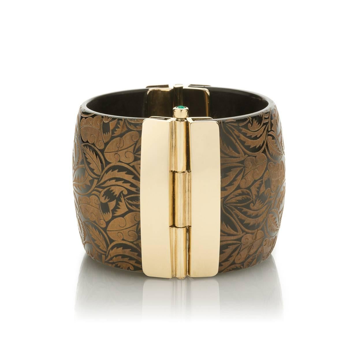 This unique cuff is hand crafted from African cow horn; engraving inspired by Fauvist textiles of 1900s Paris. The intricate pin-clasp is set with the finest emerald sourced from conflict-free mines in Zambia.  

This unique cuff bracelet is hand