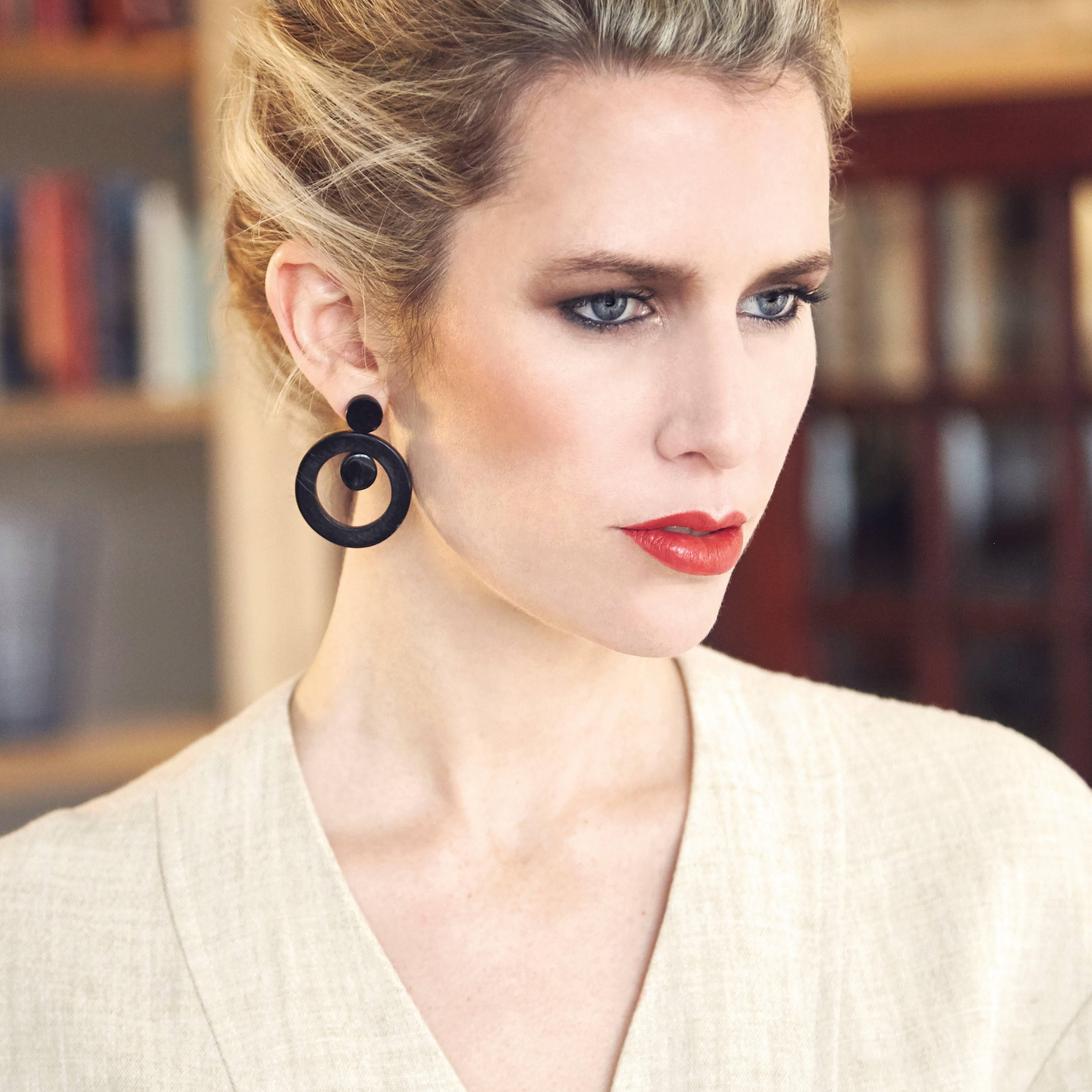 These unique earrings are carved by hand from African cow horn by artisans in Kenya, East Africa. 

Handmade from natural materials with silver pin-backs. Please note that horn graining and slight irregularities may occur. 

The Fouché collection