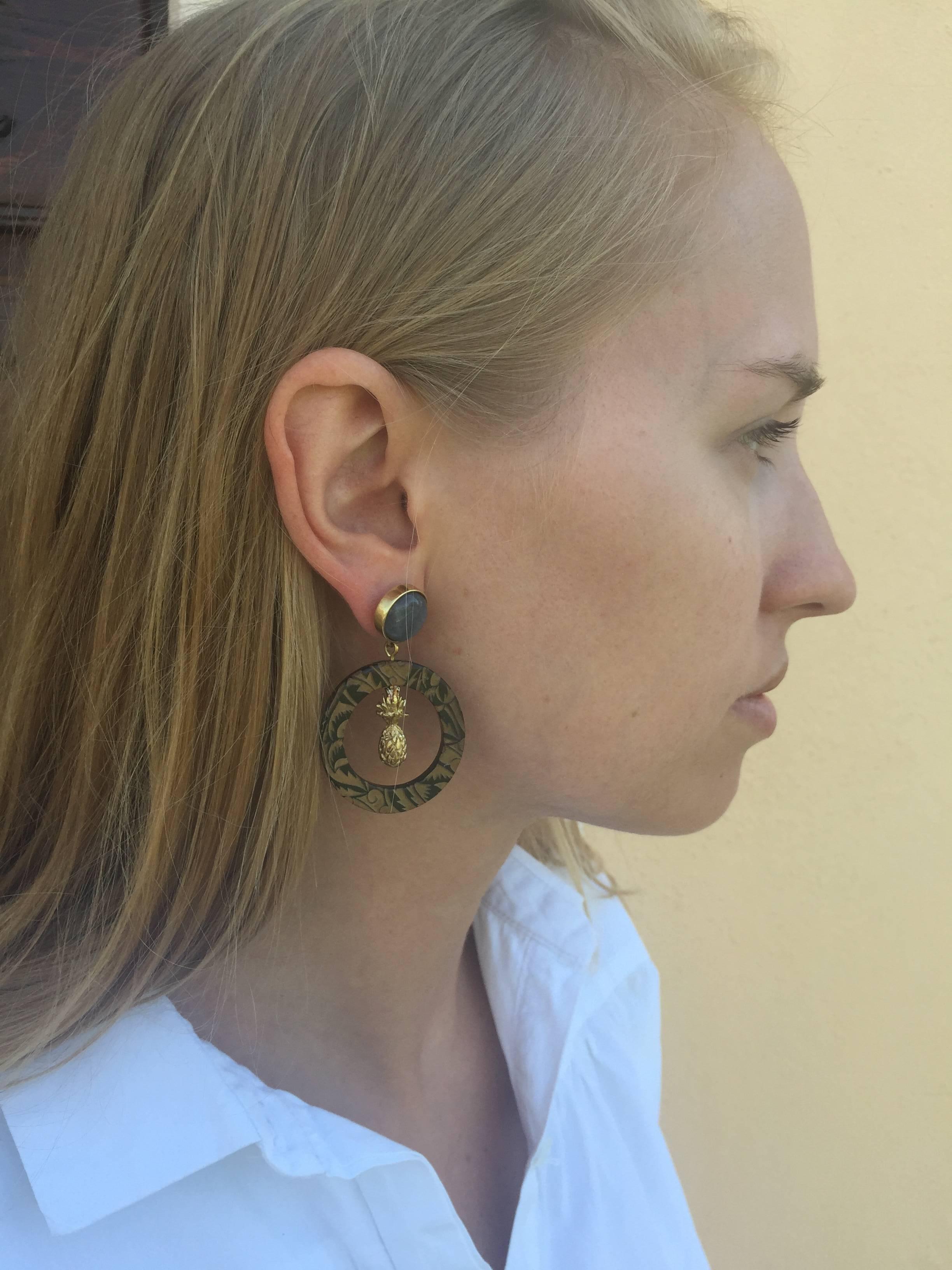 Earrings made of African cow horn engraved with art deco design; set with labradorite gemstone in blue gold color sourced from ethical mines in Madagascar, Africa. 

Earrings are hand crafted from natural materials so horn graining and slight