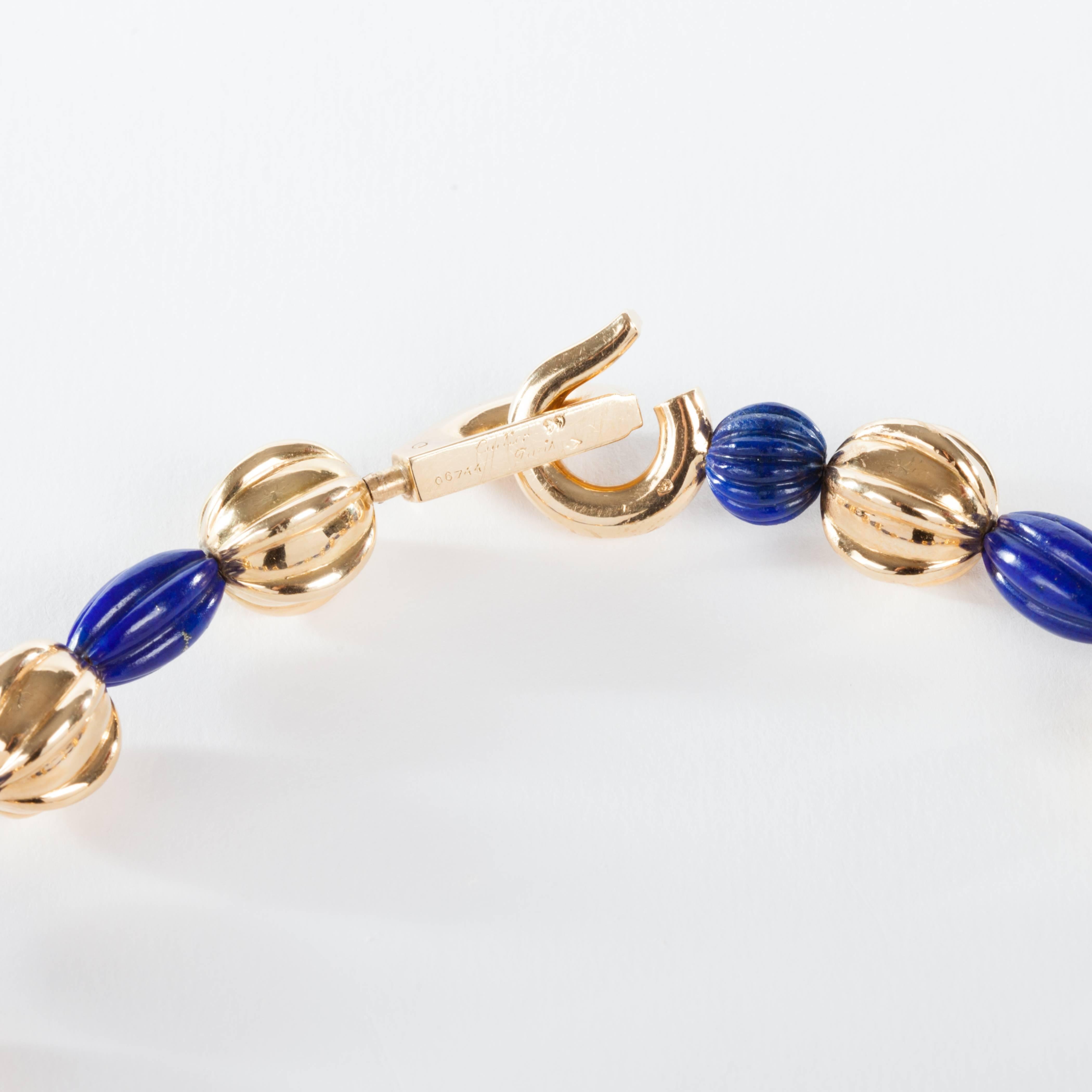 Cartier Lapis Lazuli Gold Diamond Bead Necklace. From a unique collection of vintage beaded jewelry.

The necklace has 12 lapis lazuli beads, 12 gold beads approximately 12mm.
The hook closure is diamond set. Total weight approximately 1.60