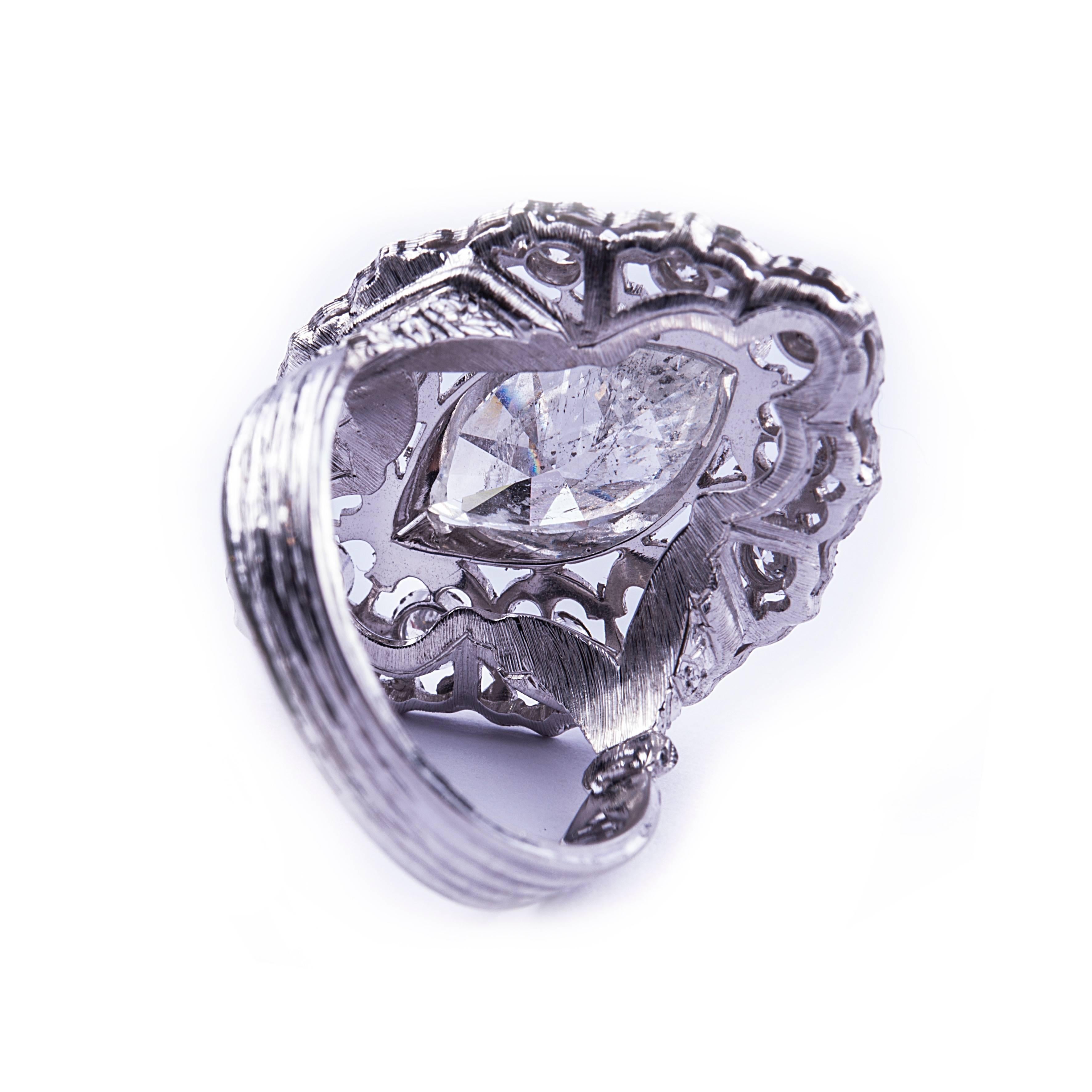 Marquise Diamond Ring surrounded by round diamonds

Marquise Cut Diamond: 3.5 ct ca.
Round Diamonds: 1 ct ca.