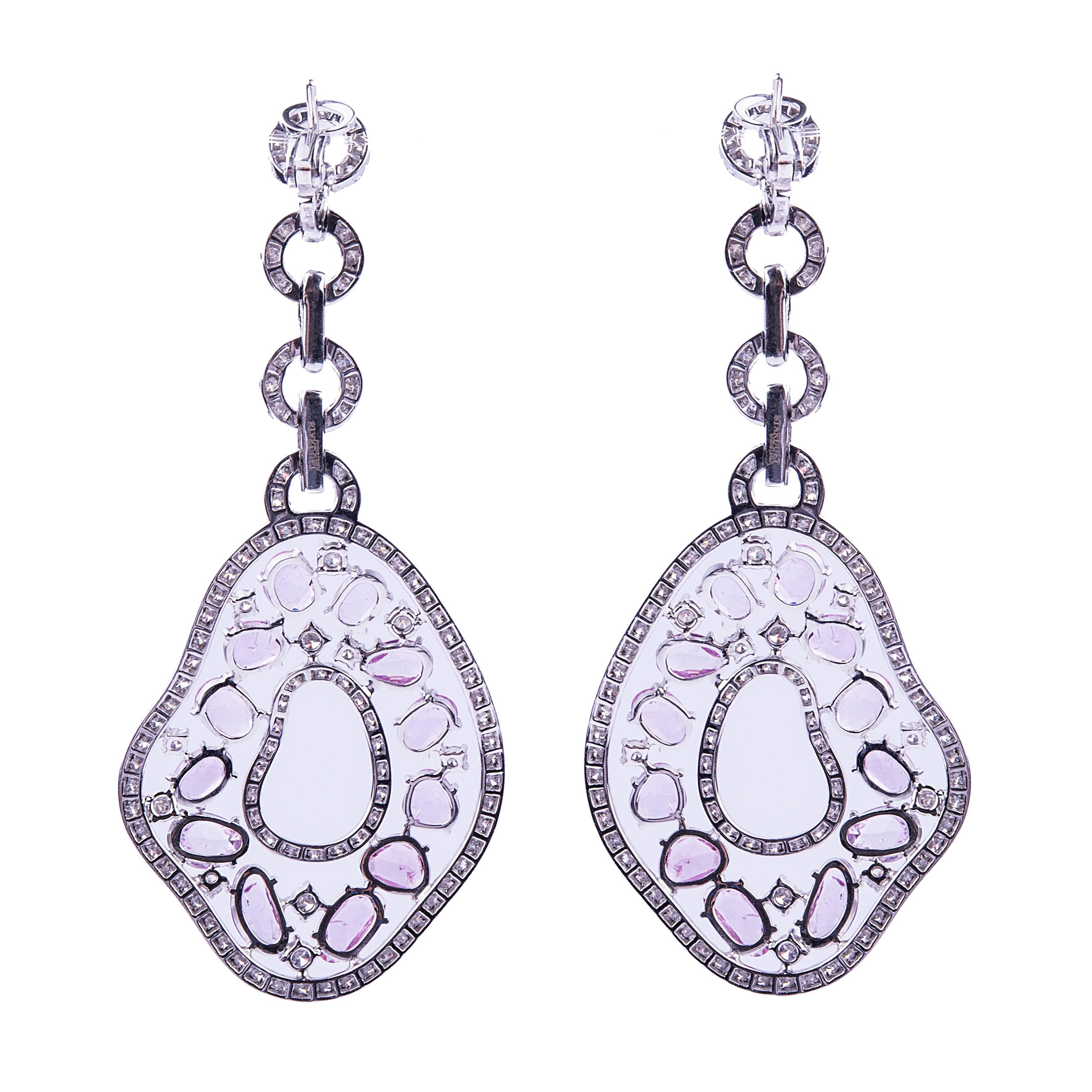A raffinate pair of pink sapphire and diamond pendant earrings featuring 12 ct circa of pink sapphires and 5.50 ct circa of G color VS diamonds.