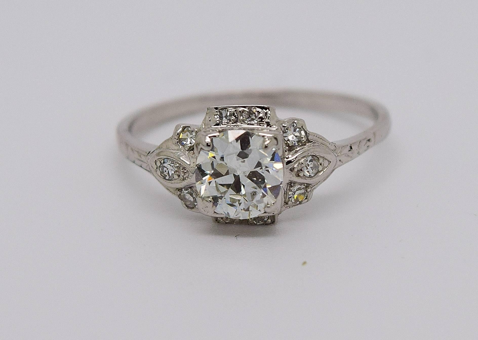 Beautiful Art Deco old European cut diamond engagement ring set in platinum. The center old European cut diamond is approximately 0.70 carats and is G-H in color and Si1 in clarity. The ring also contains 10 side old cut diamonds weighing