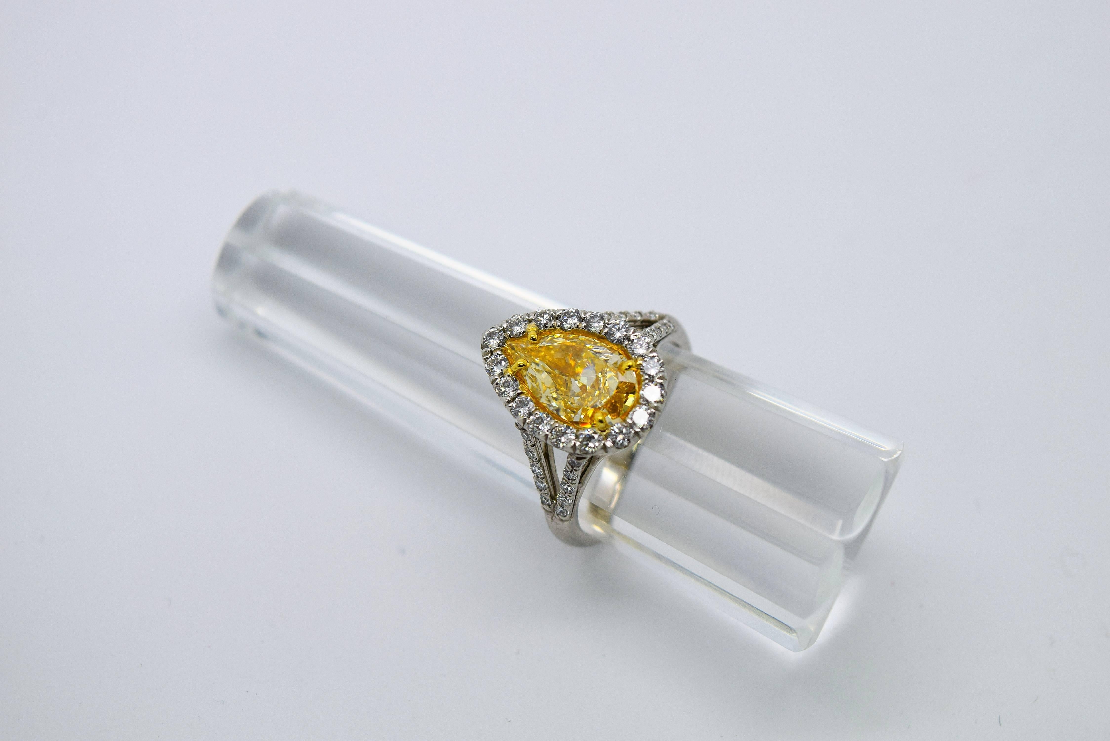 Gorgeous natural yellow pear shape diamond in a platinum and 18k yellow gold ring. 
Weight: 7.38 Grams 
Stones: Yellow and white Diamonds 
Center Diamond: 2.01ct Fancy Intense Yellow Color VS2 Clarity Excellent Cut 
Shape: Round Brilliant Cut